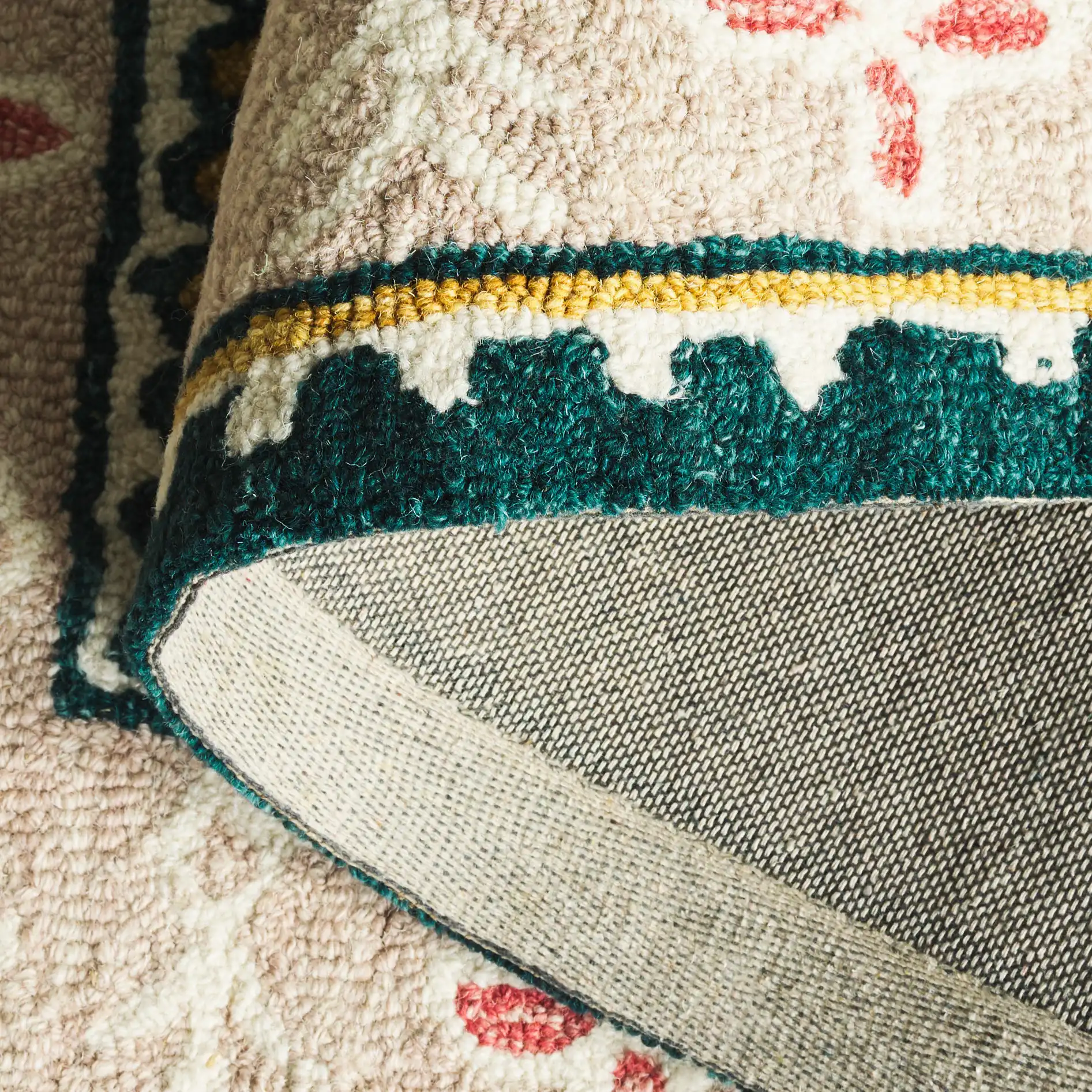 Jardin Floral Border Hand-Tufted Wool Rug in Dark Green / Pink in a styled room