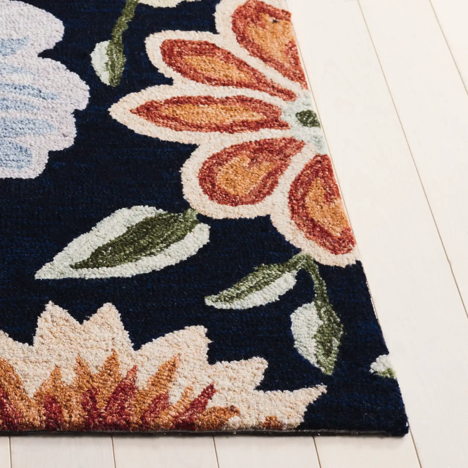 Jardin Daisy Field Hand-Tufted Wool Rug in Black / Green in a styled room