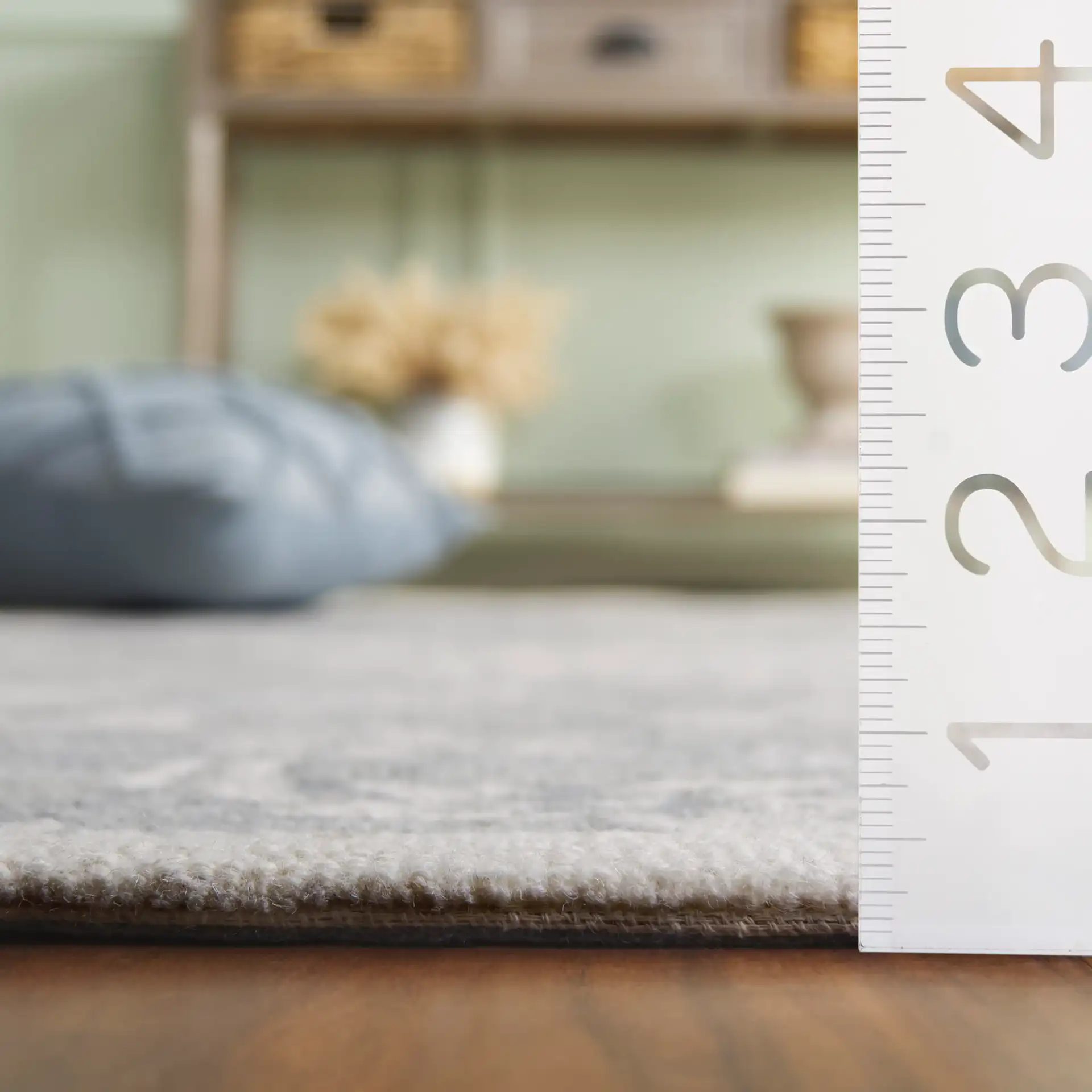 Jardin Bordered Floral Hand-Tufted Wool Rug in Gray / Ivory in a styled room