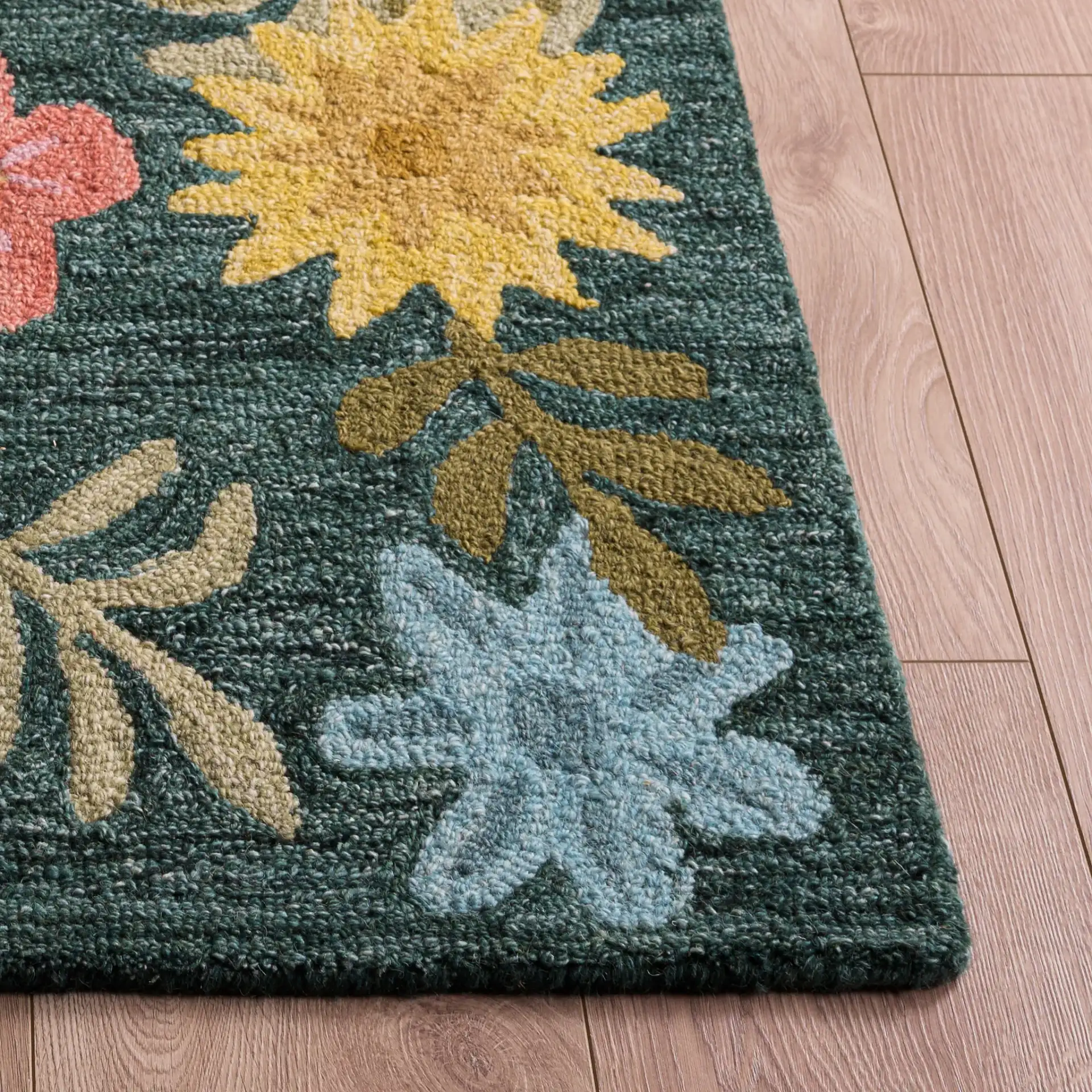 Jardin Folk Floral Hand-Tufted Wool Rug in Green / Blue in a styled room