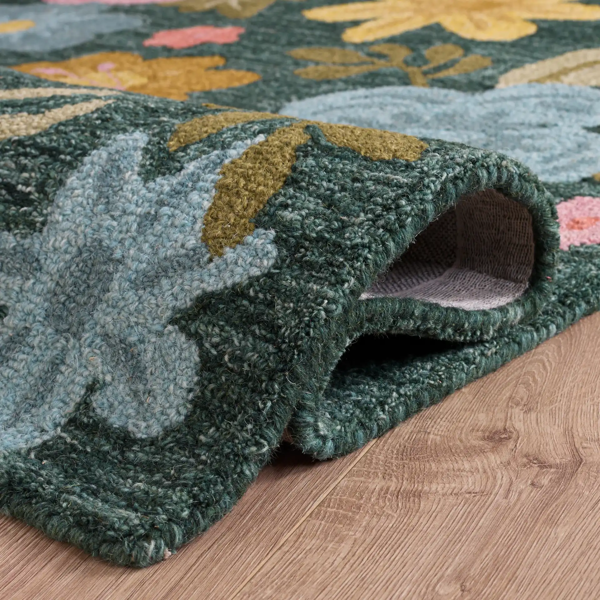 Jardin Folk Floral Hand-Tufted Wool Rug in Green / Blue in a styled room