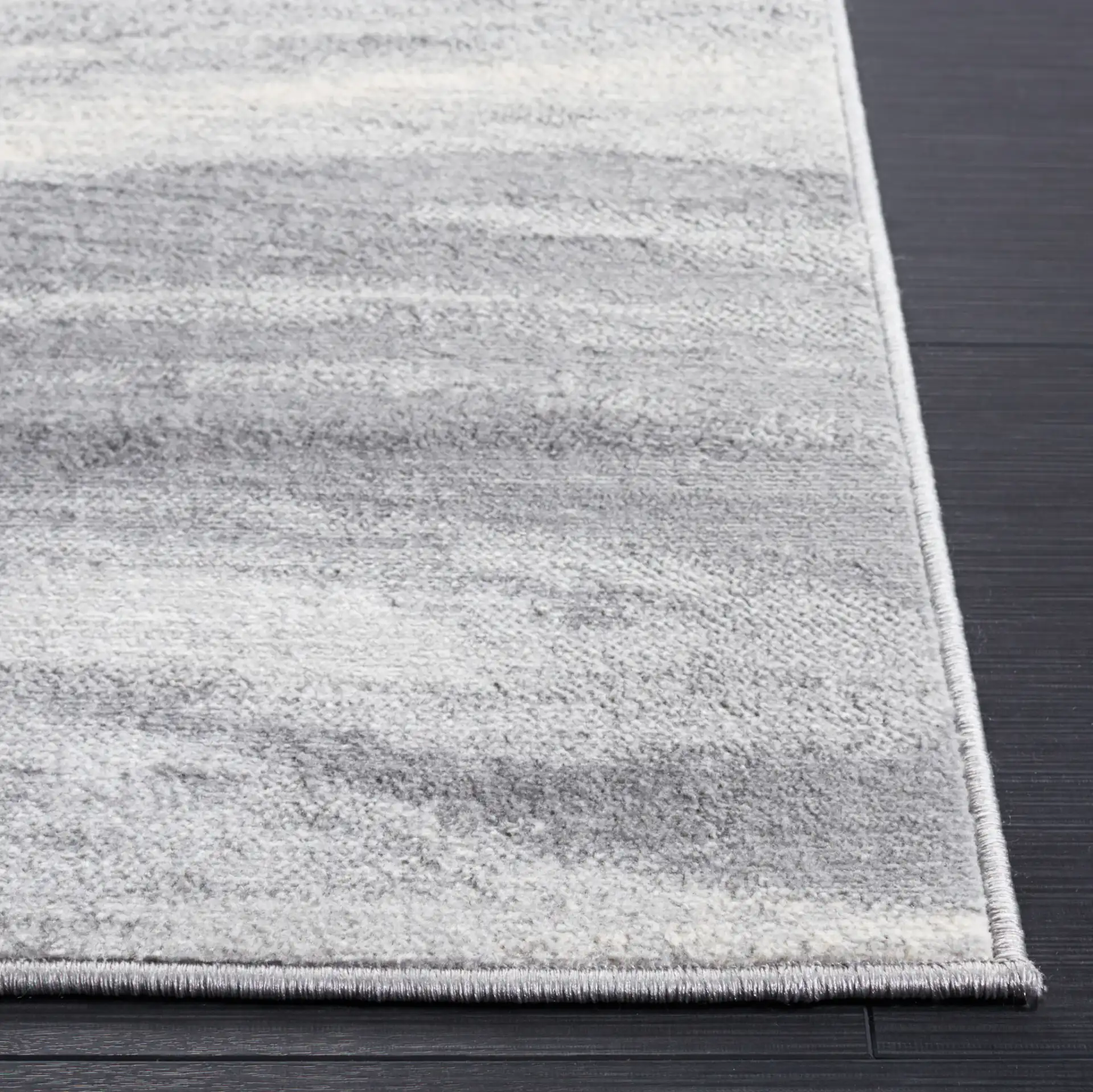Jasper Abstract Wave Rug in Gray / Ivory in a styled room