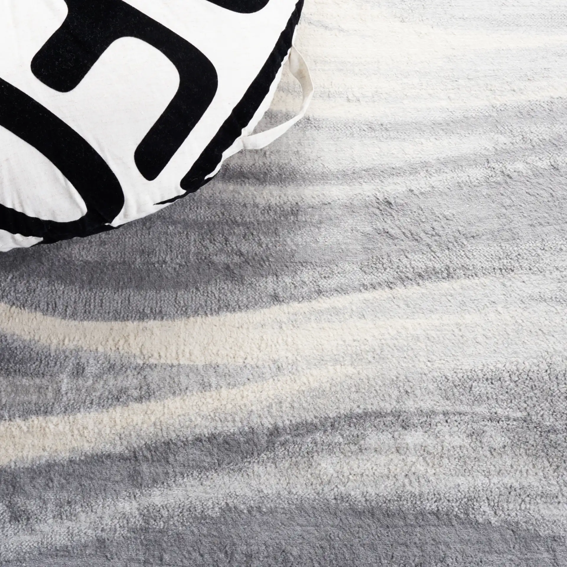 Jasper Abstract Wave Rug in Gray / Ivory in a styled room