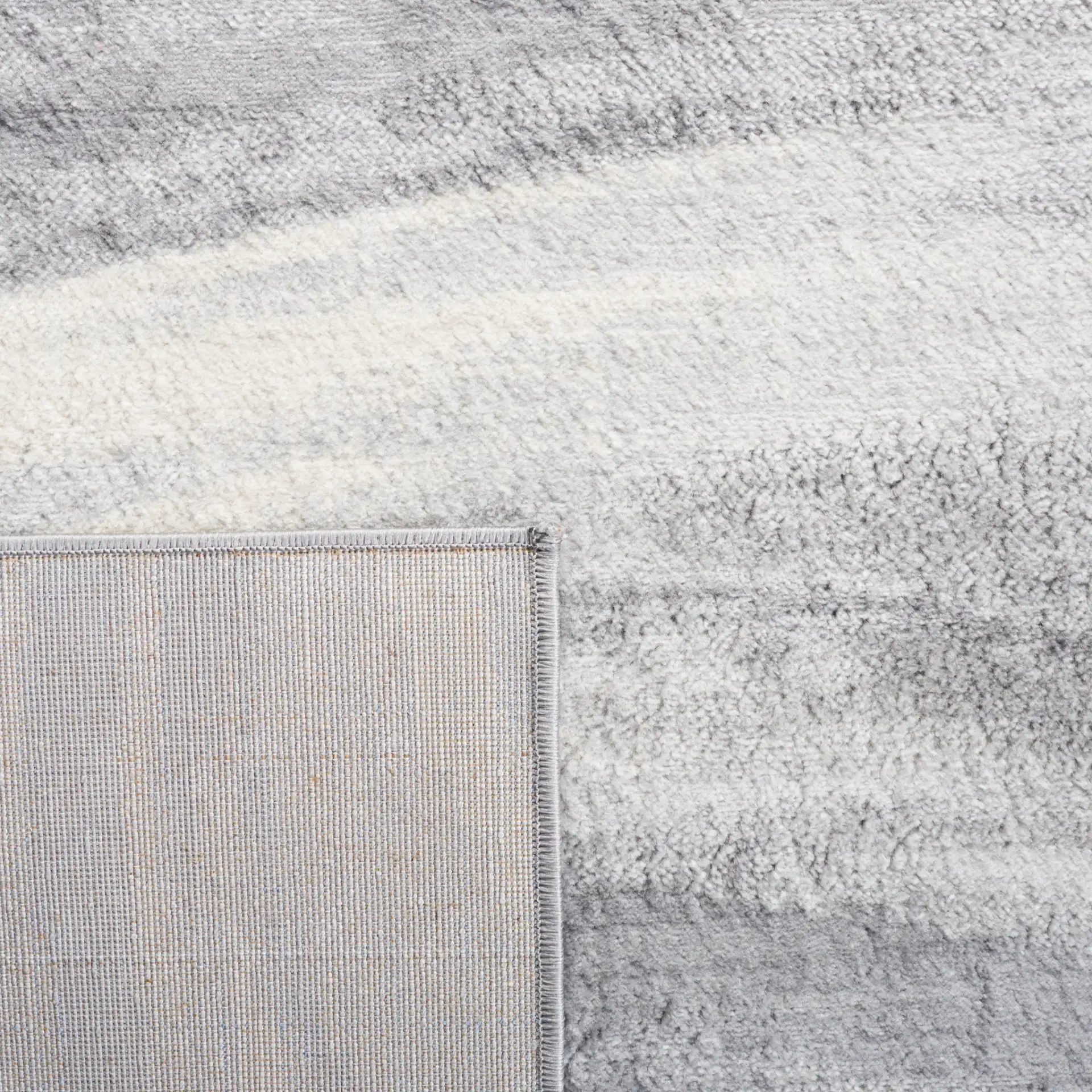 Jasper Abstract Wave Rug in Gray / Ivory in a styled room