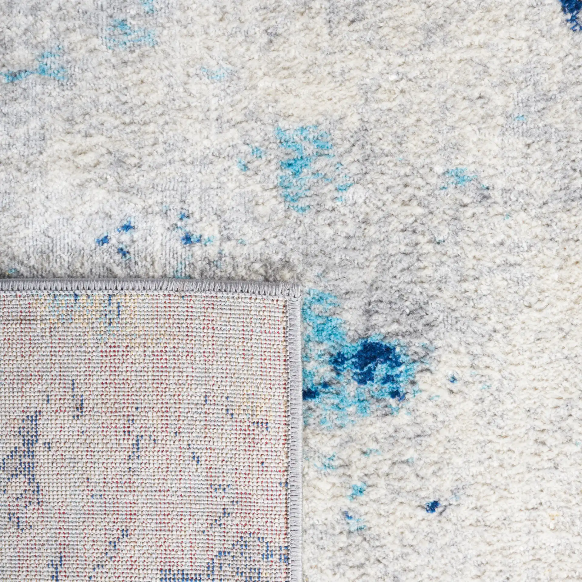 Jasper Marble Rug in Ivory / Blue in a styled room