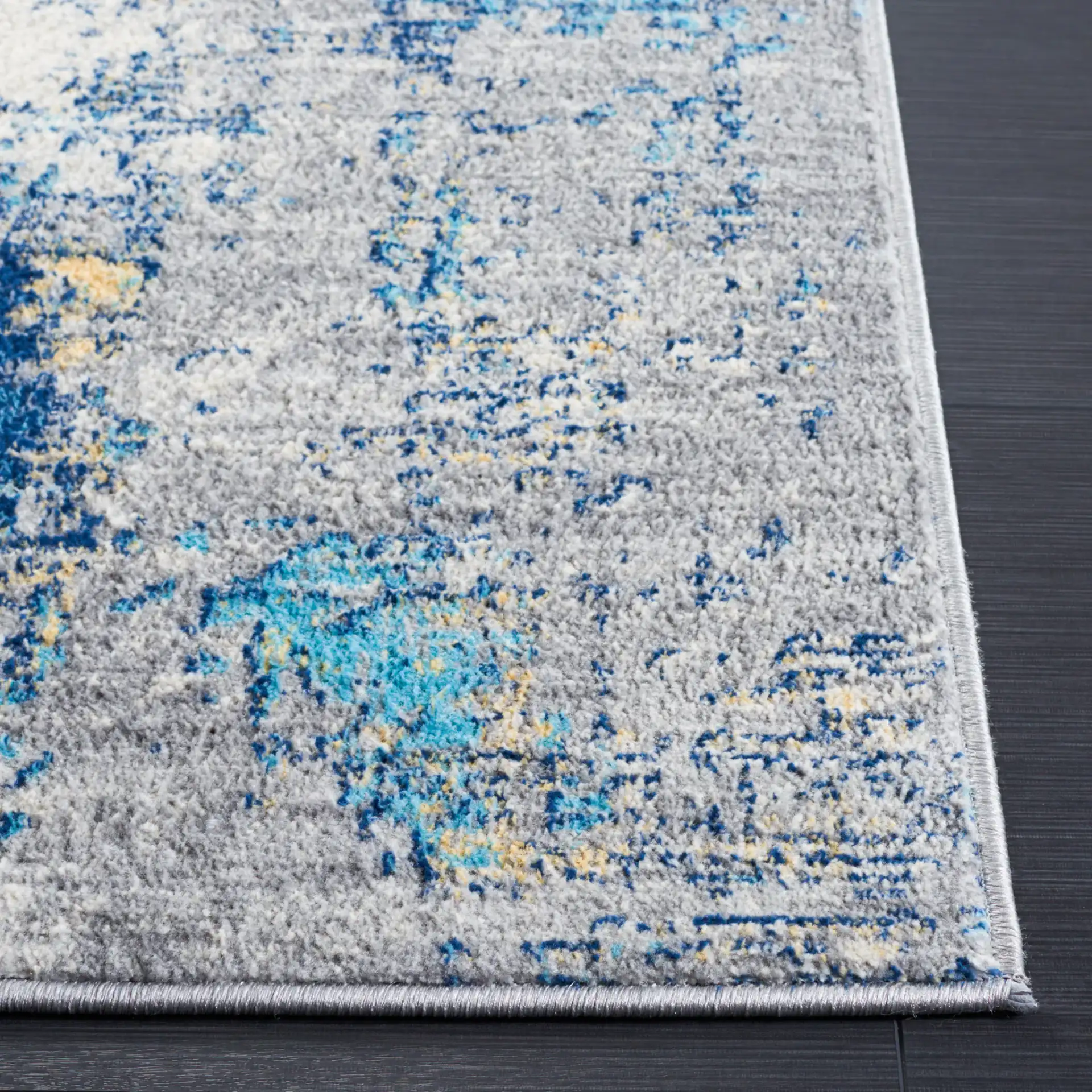 Jasper Abstract Rug in Gray / Blue in a styled room