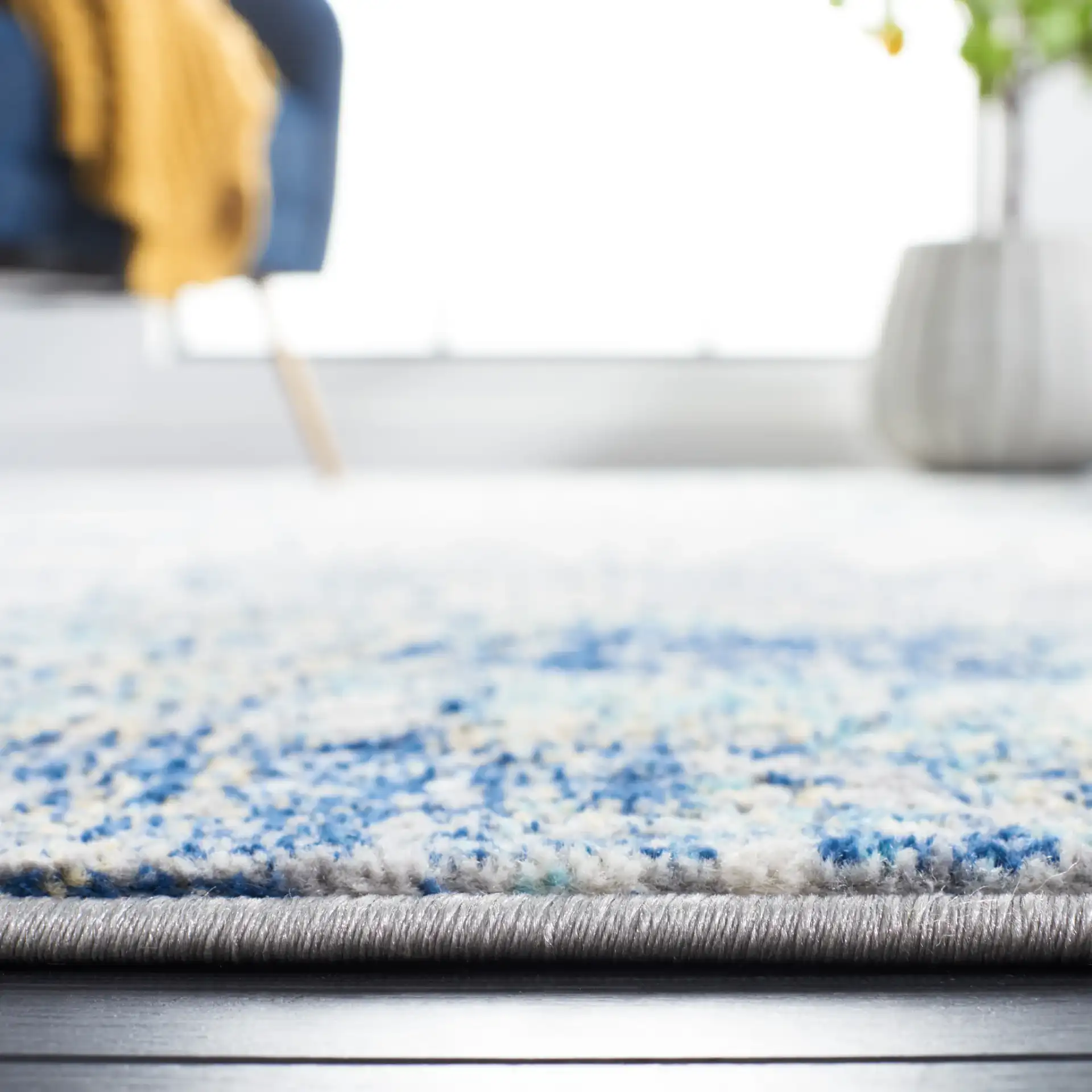 Jasper Abstract Rug in Gray / Blue in a styled room