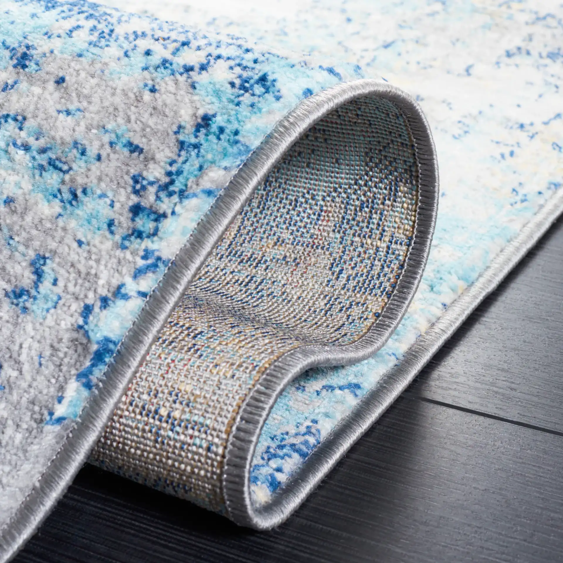 Jasper Abstract Rug in Gray / Blue in a styled room