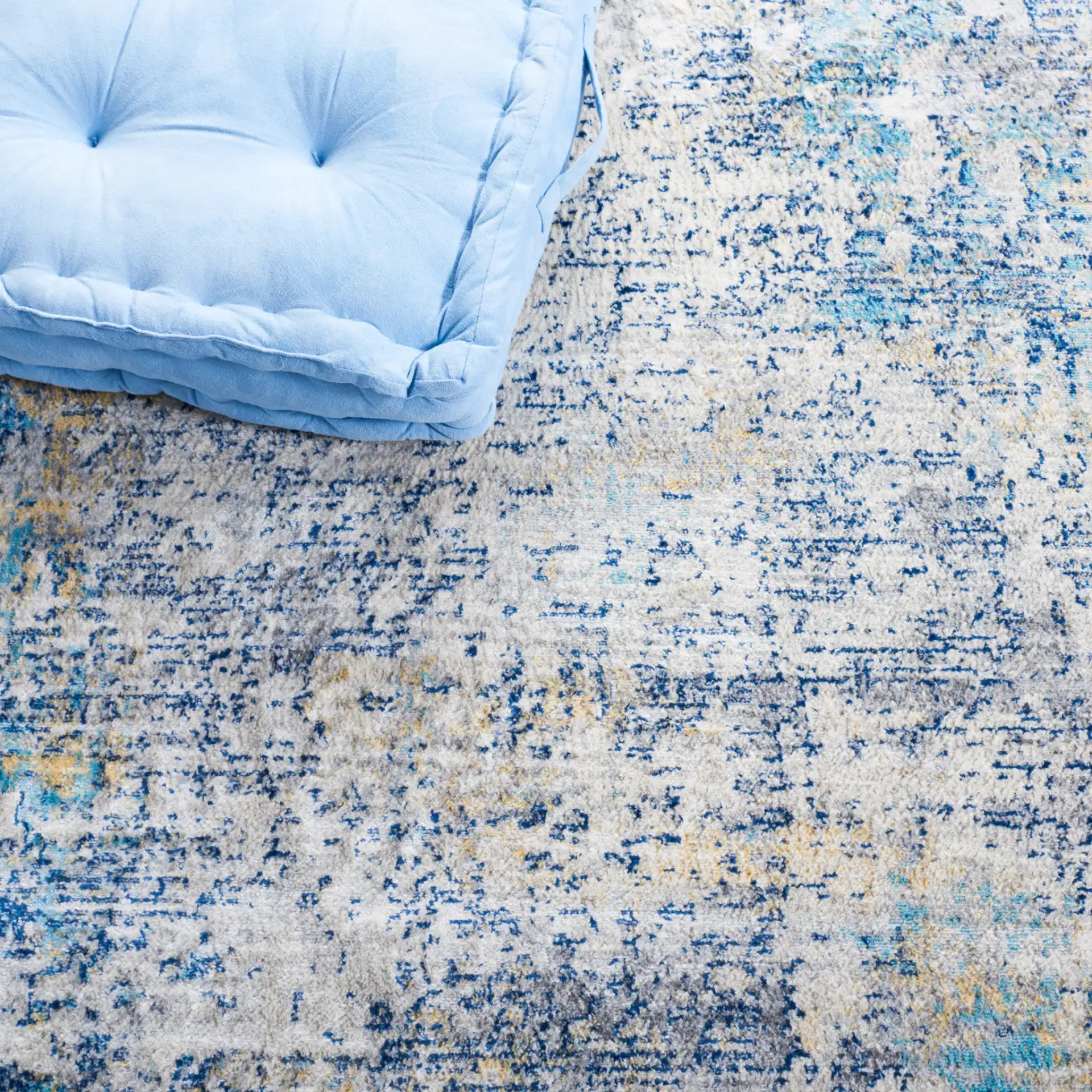 Jasper Abstract Rug in Gray / Blue in a styled room