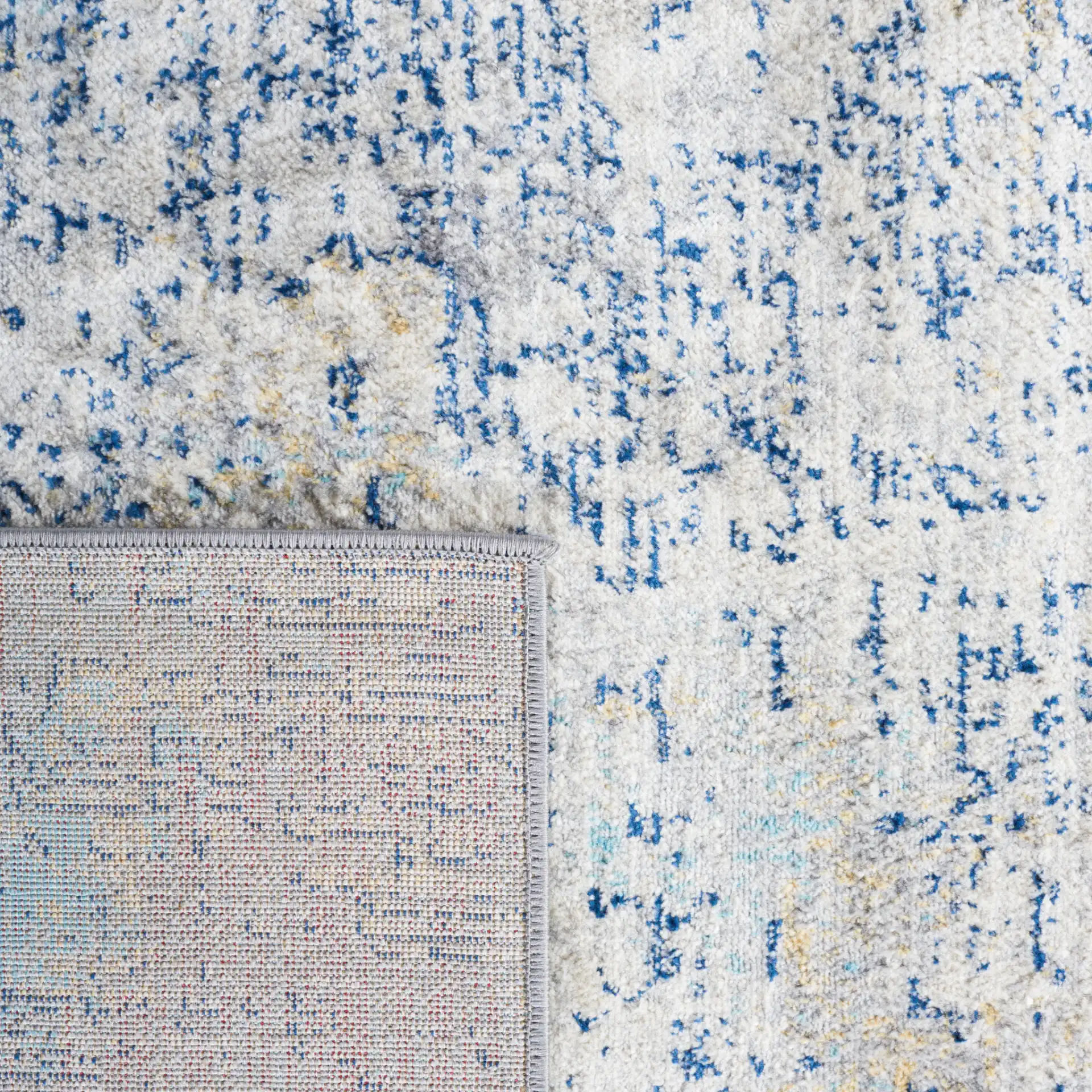 Jasper Abstract Rug in Gray / Blue in a styled room