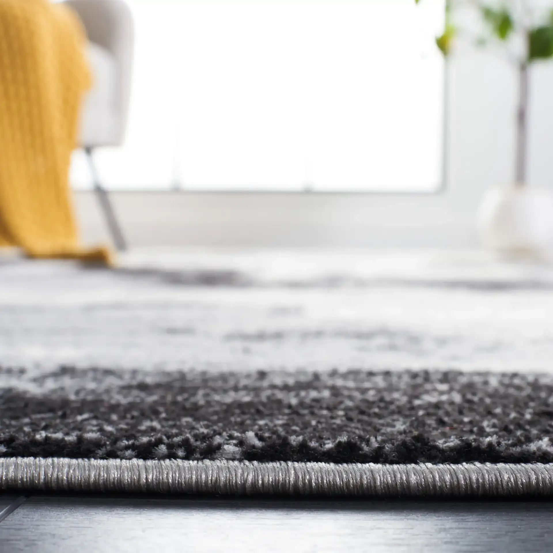 Jasper Abstract Block Rug in Black / Ivory in a styled room
