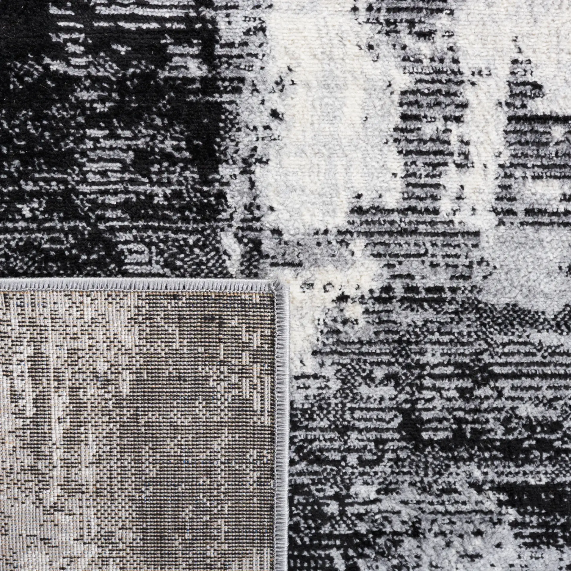 Jasper Abstract Block Rug in Black / Ivory in a styled room
