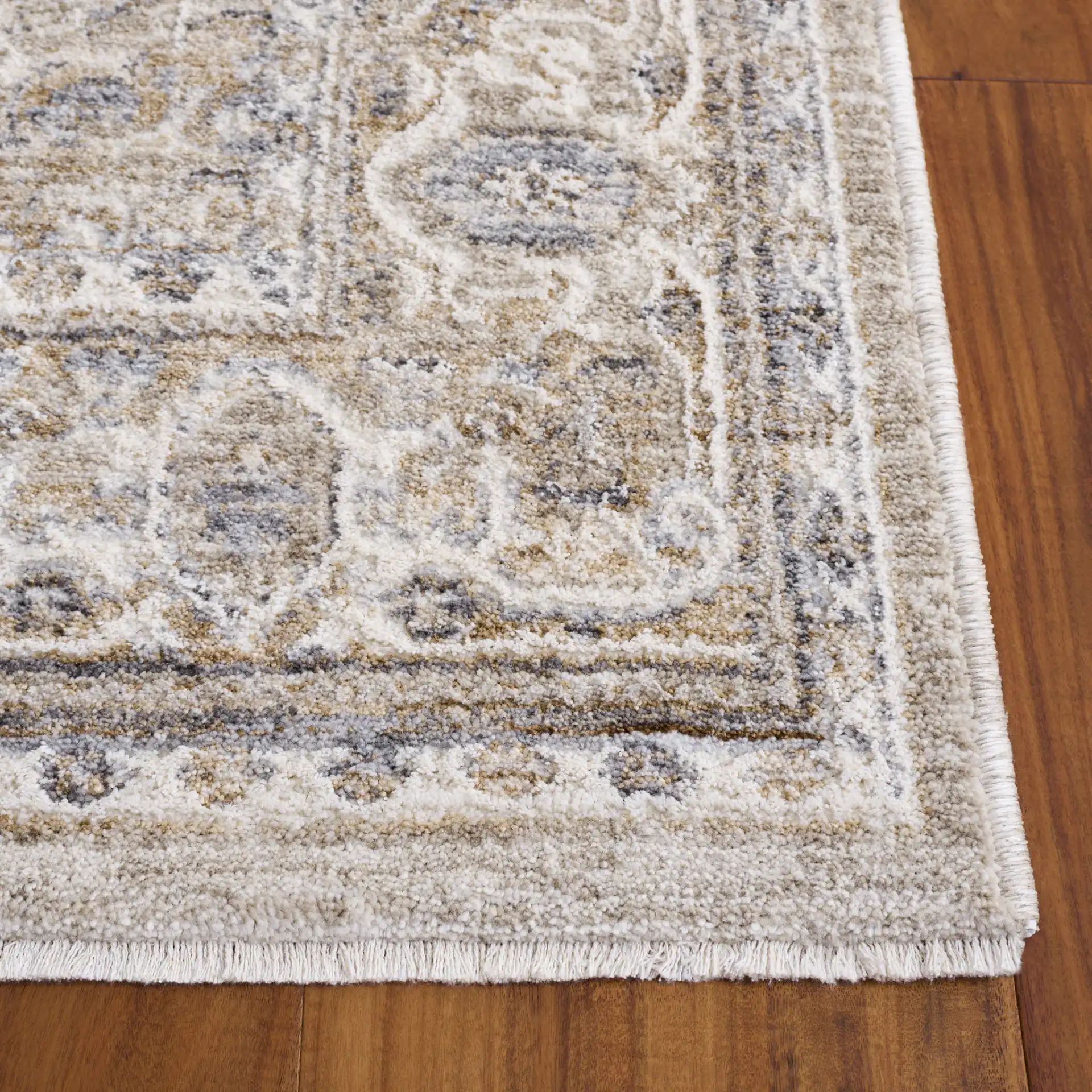 Kendal Distressed Medallion Bordered Rug in Gray / Ivory Beige in a styled room