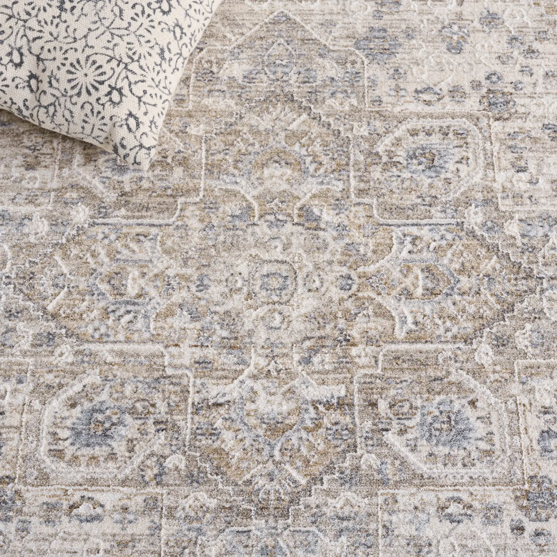 Kendal Distressed Medallion Bordered Rug in Gray / Ivory Beige in a styled room