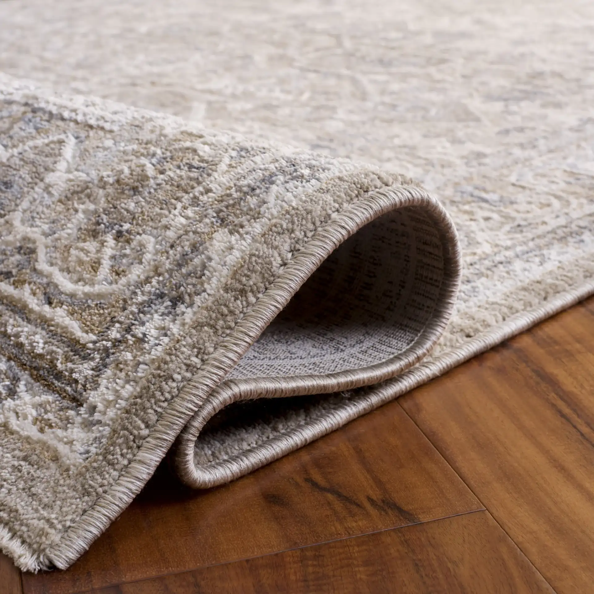 Kendal Distressed Medallion Bordered Rug in Gray / Ivory Beige in a styled room