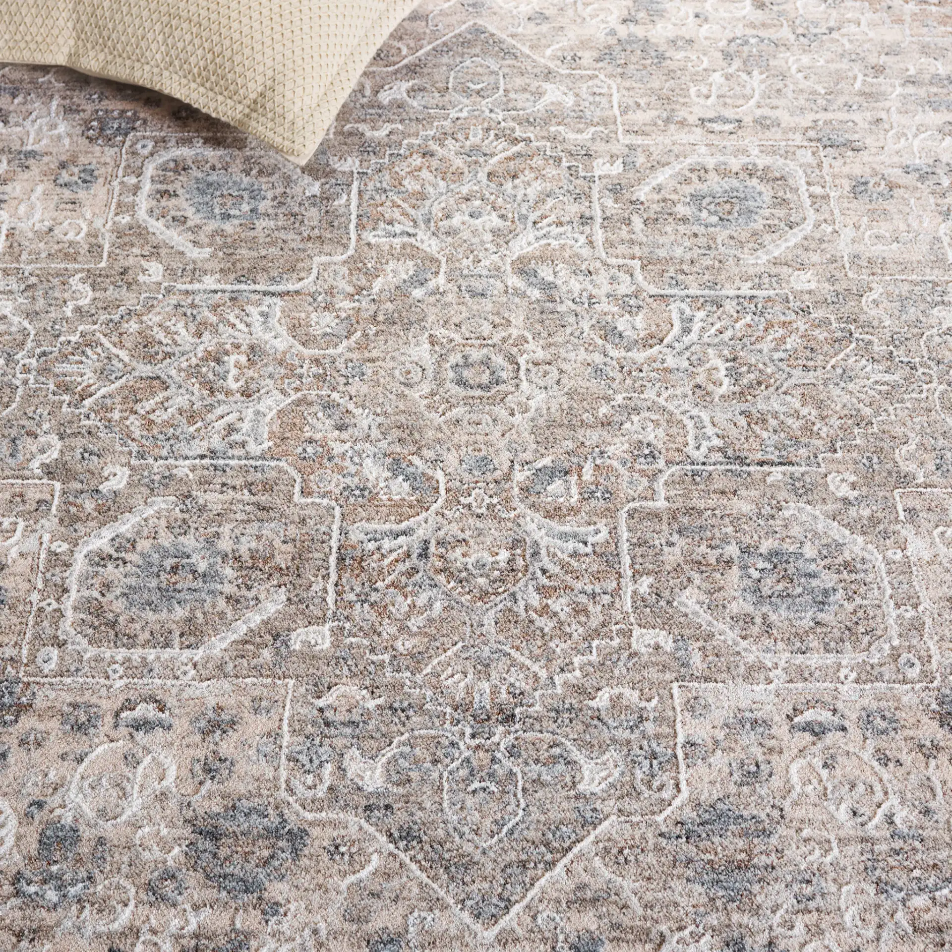 Kendal Distressed Medallion Bordered Rug in Gray / Ivory Beige in a styled room