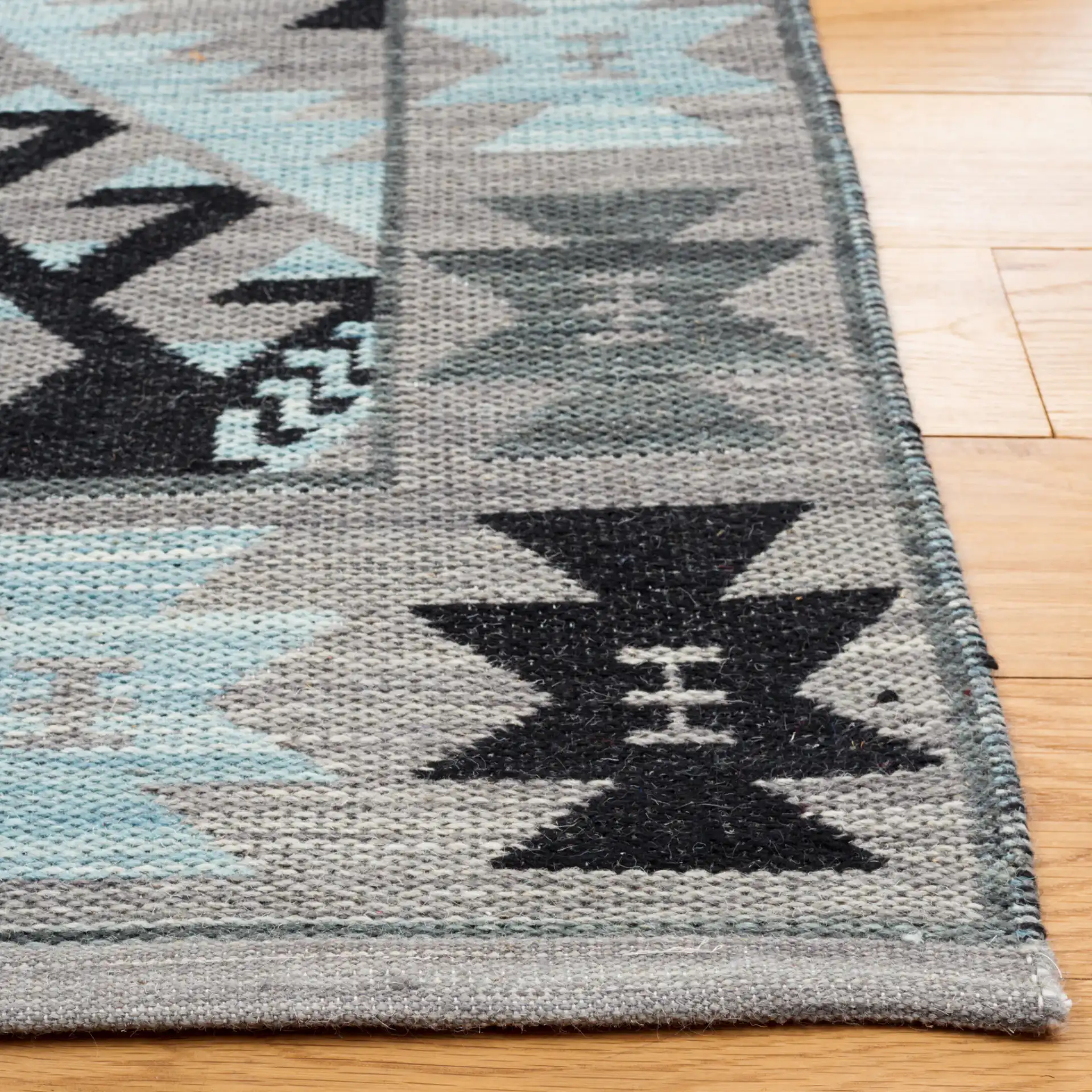 Kilim Tribal Diamond Medallion Hand-Woven Rug in Gray / Black in a styled room