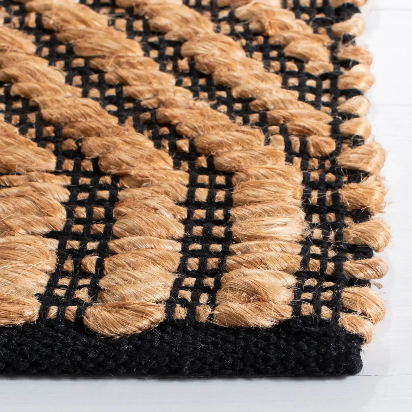 Kilim Coastal Diamond Chevron Hand-Woven Jute Rug in Natural / Black in a styled room
