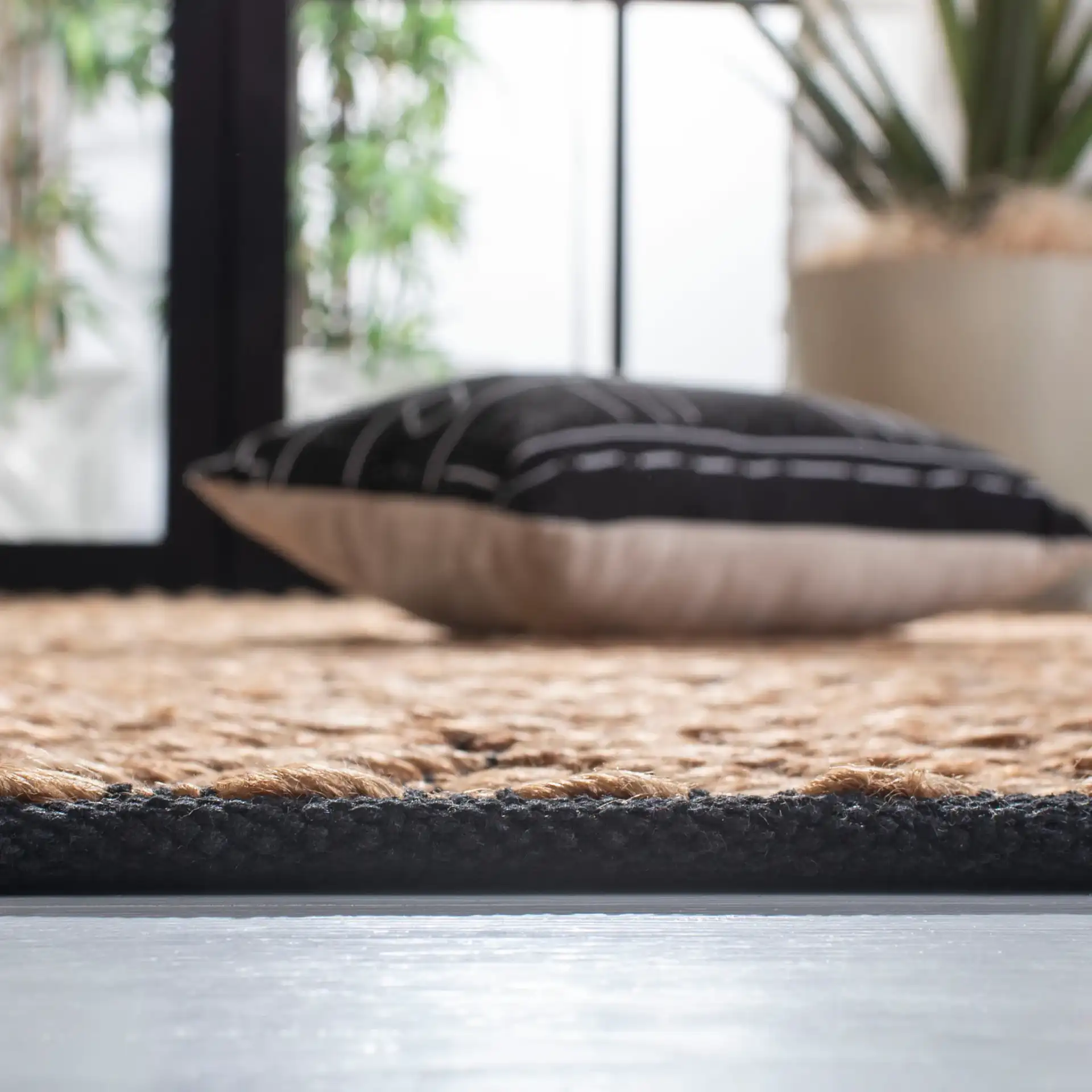 Kilim Coastal Diamond Chevron Hand-Woven Jute Rug in Natural / Black in a styled room