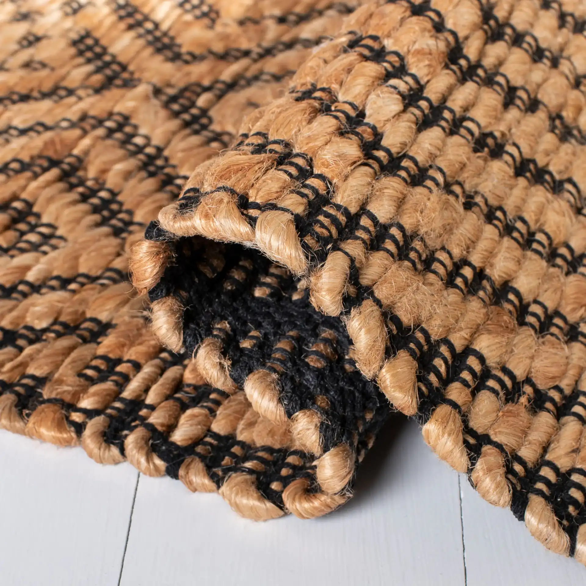 Kilim Coastal Diamond Chevron Hand-Woven Jute Rug in Natural / Black in a styled room