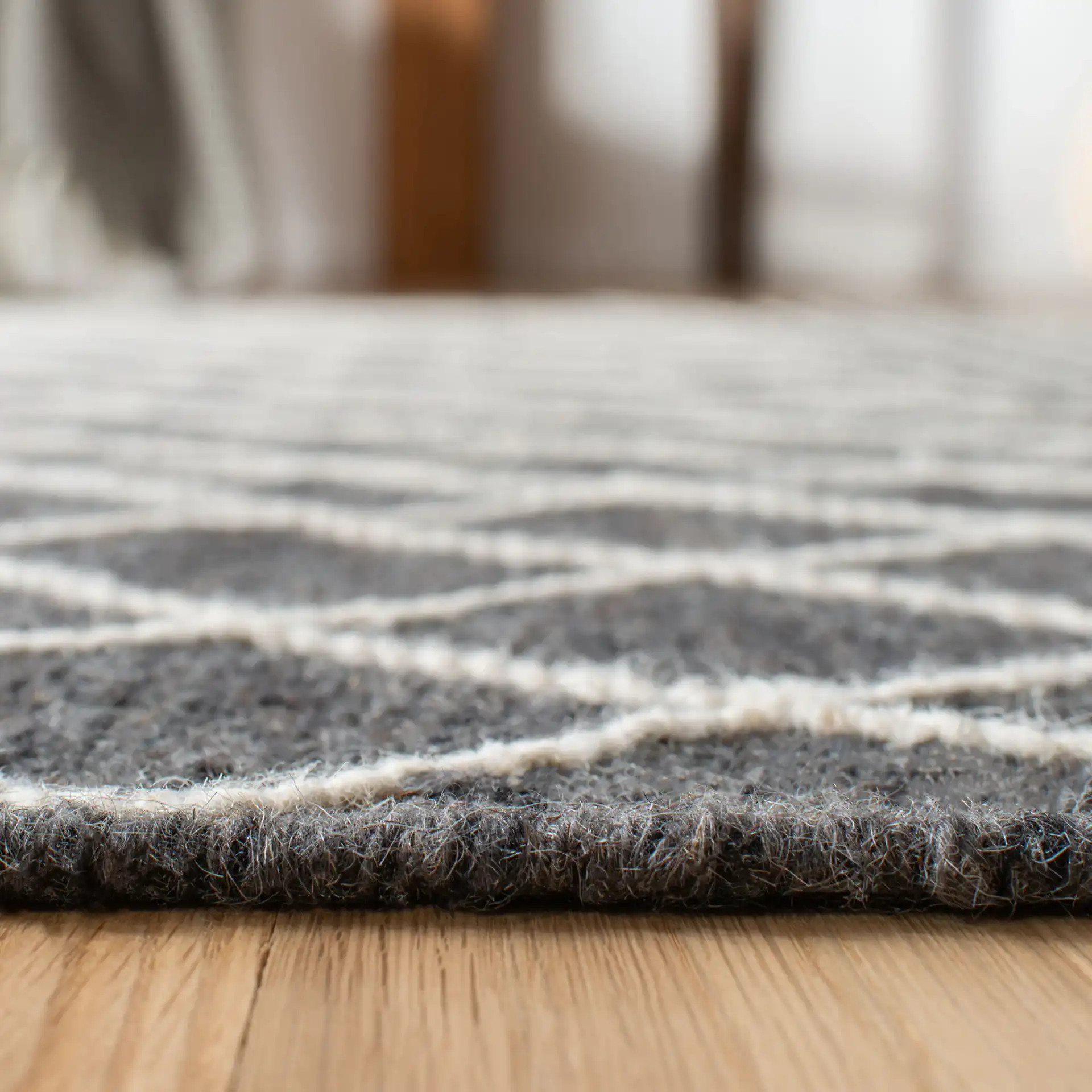 Kilim Banded Diamond Hand-Loomed Wool Rug in Charcoal / Ivory in a styled room