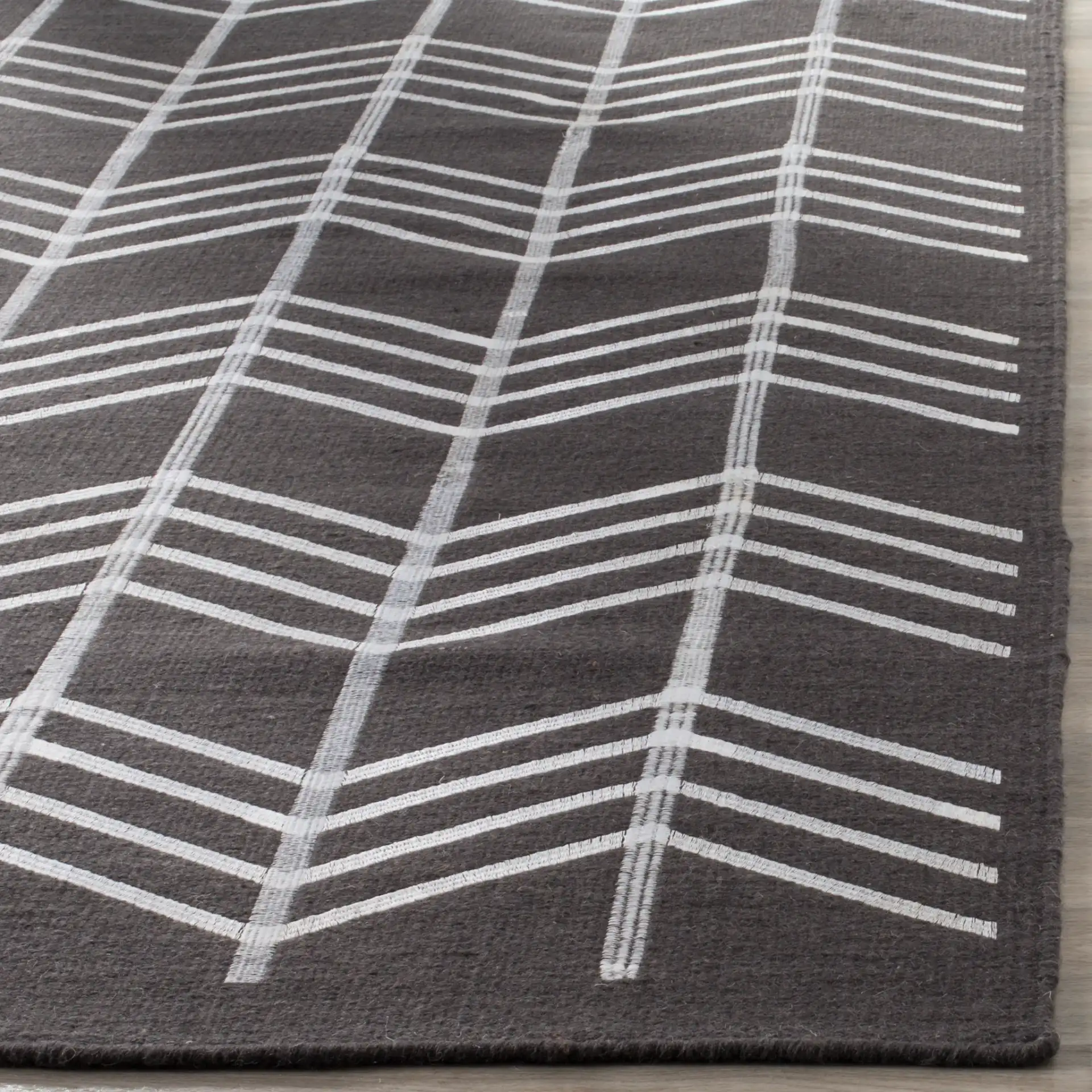 Kilim Herringbone Stripe Hand-Woven Wool Rug in Charcoal in a styled room