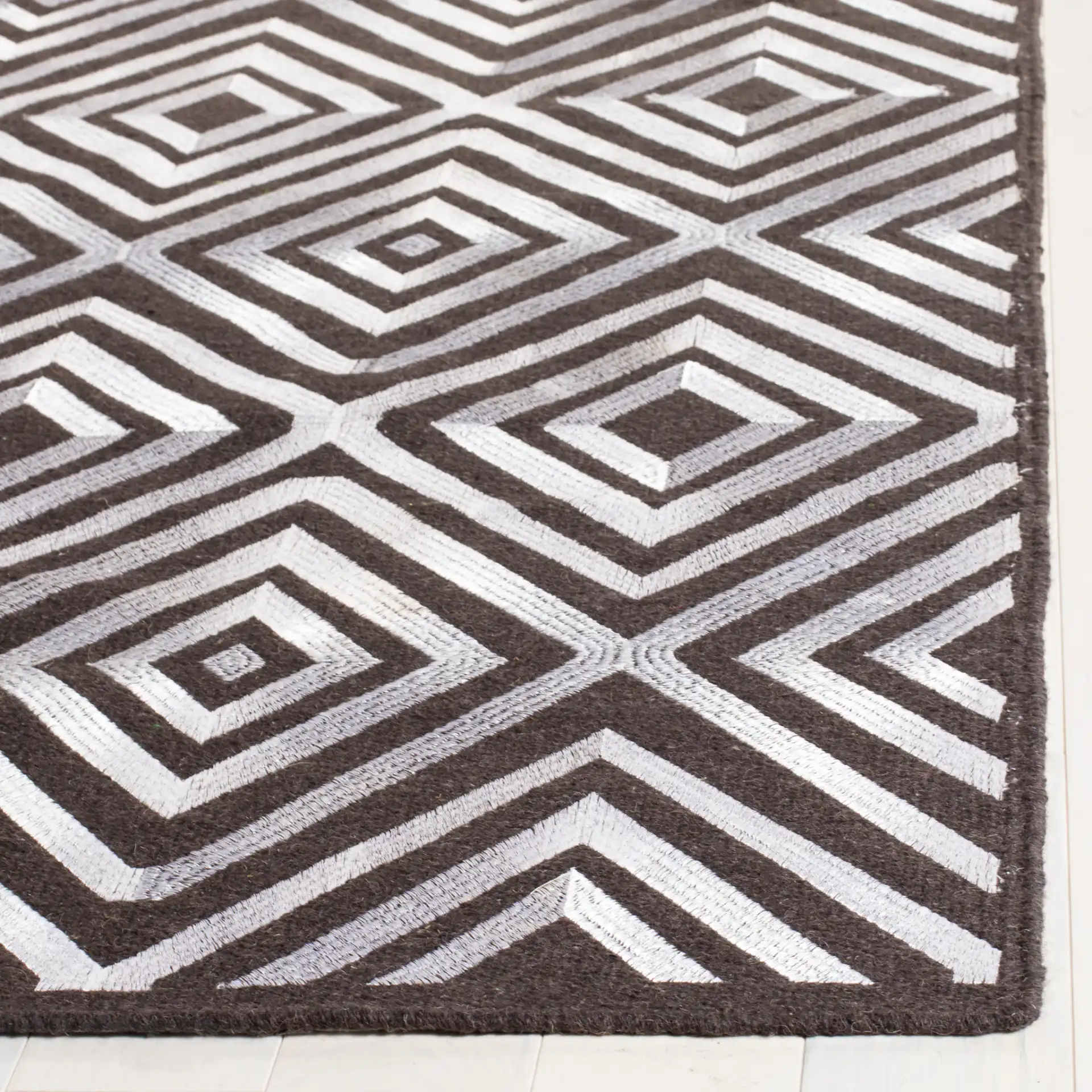 Kilim Concentric Diamond Hand-Woven Wool Rug in Charcoal in a styled room