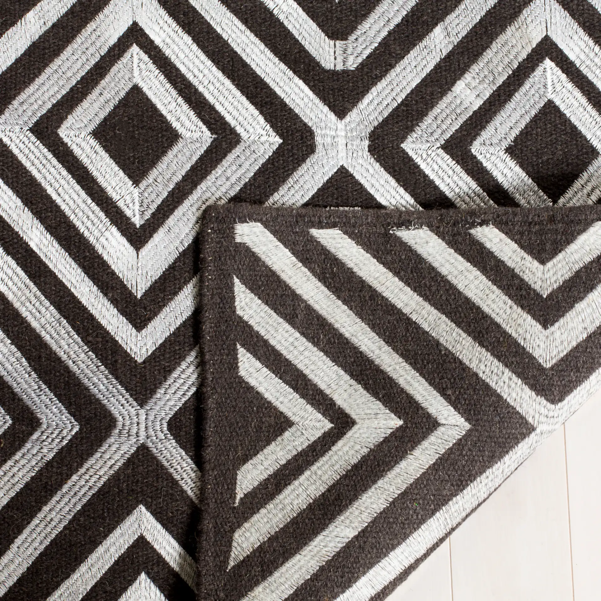 Kilim Concentric Diamond Hand-Woven Wool Rug in Charcoal in a styled room