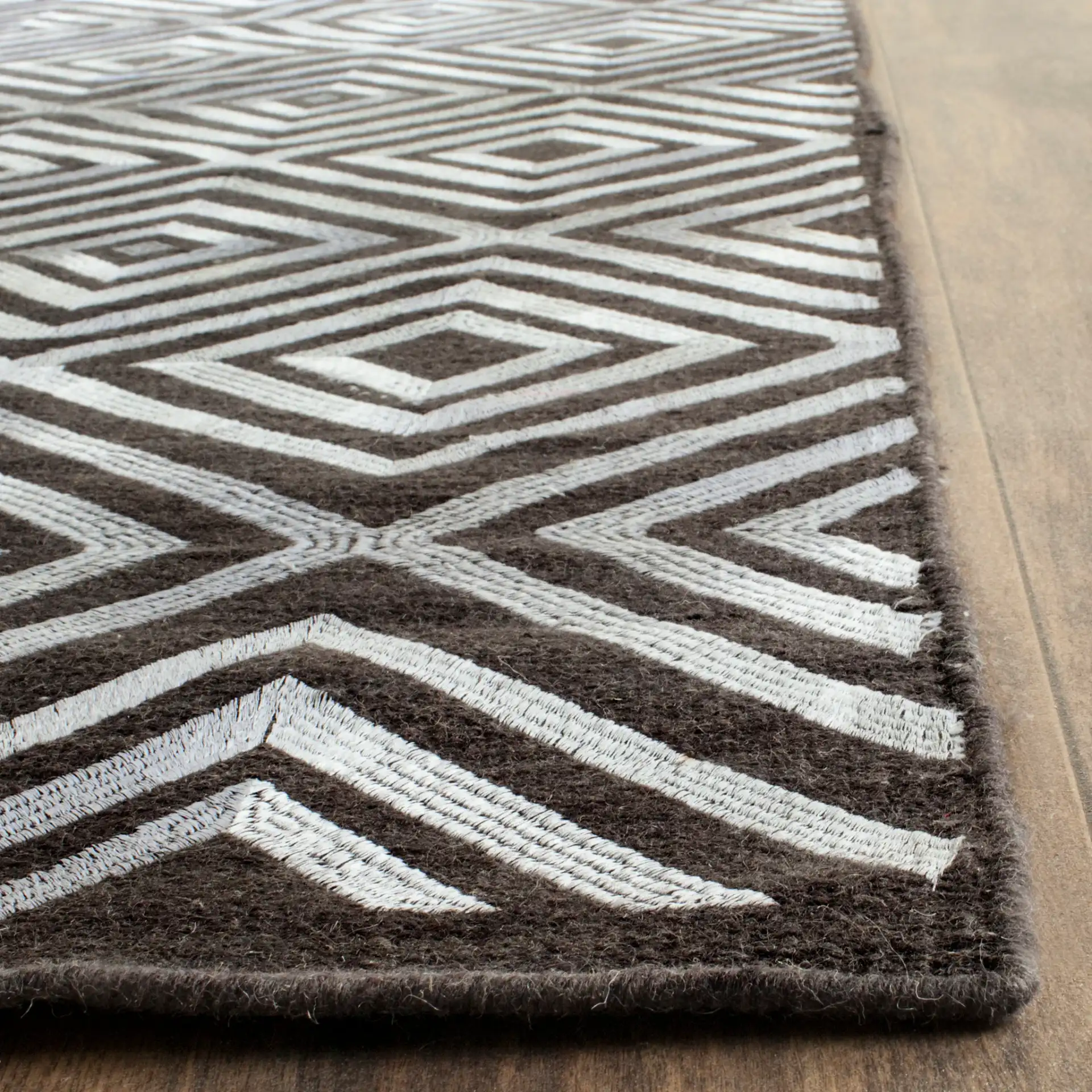 Kilim Concentric Diamond Hand-Woven Wool Rug in Charcoal in a styled room