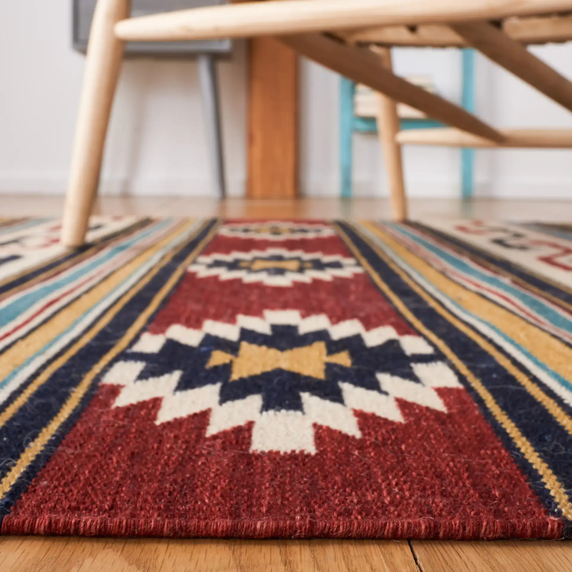 Kilim Banded Diamond Flatweave Wool Rug in Ivory / Rust in a styled room