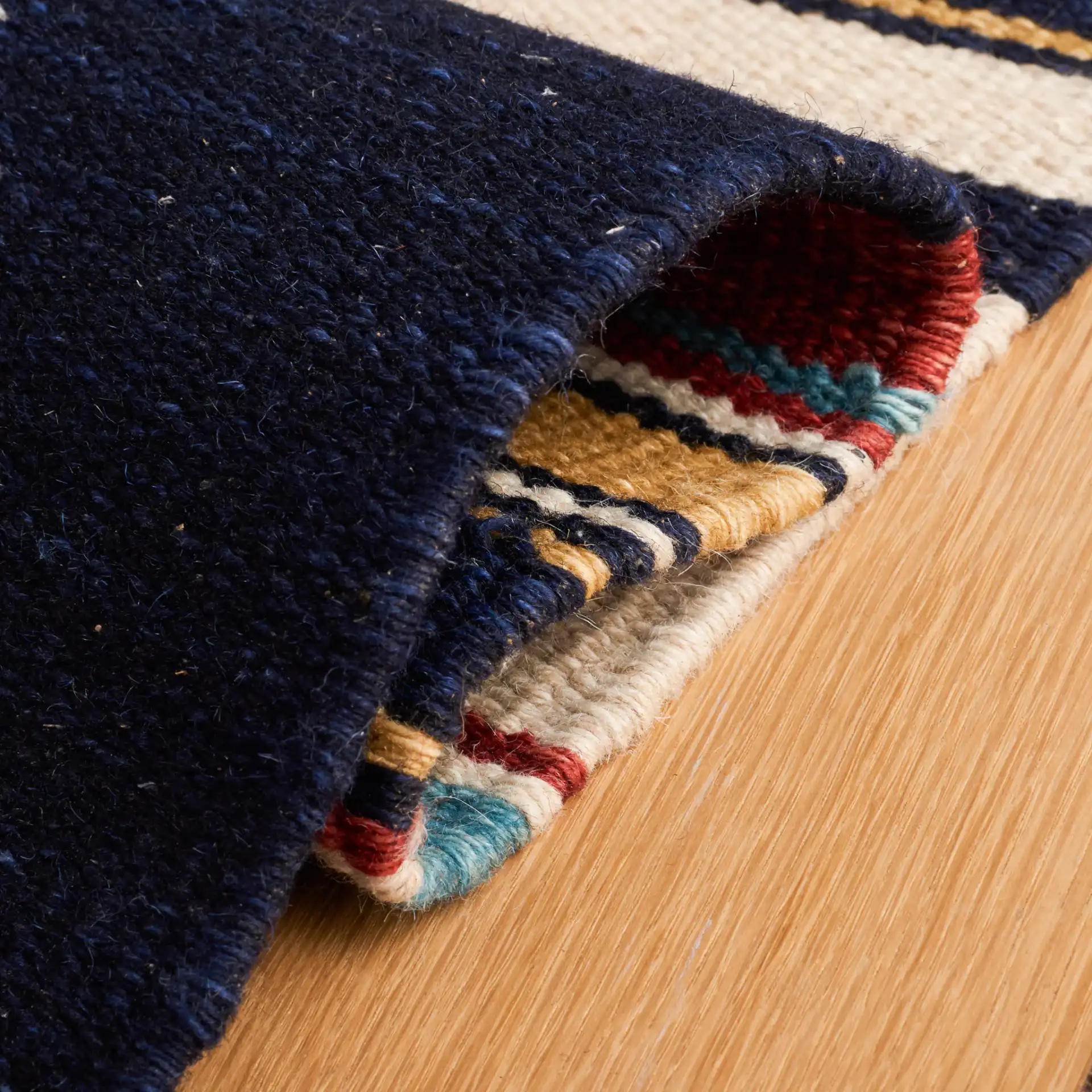Kilim Banded Diamond Flatweave Wool Rug in Ivory / Rust in a styled room