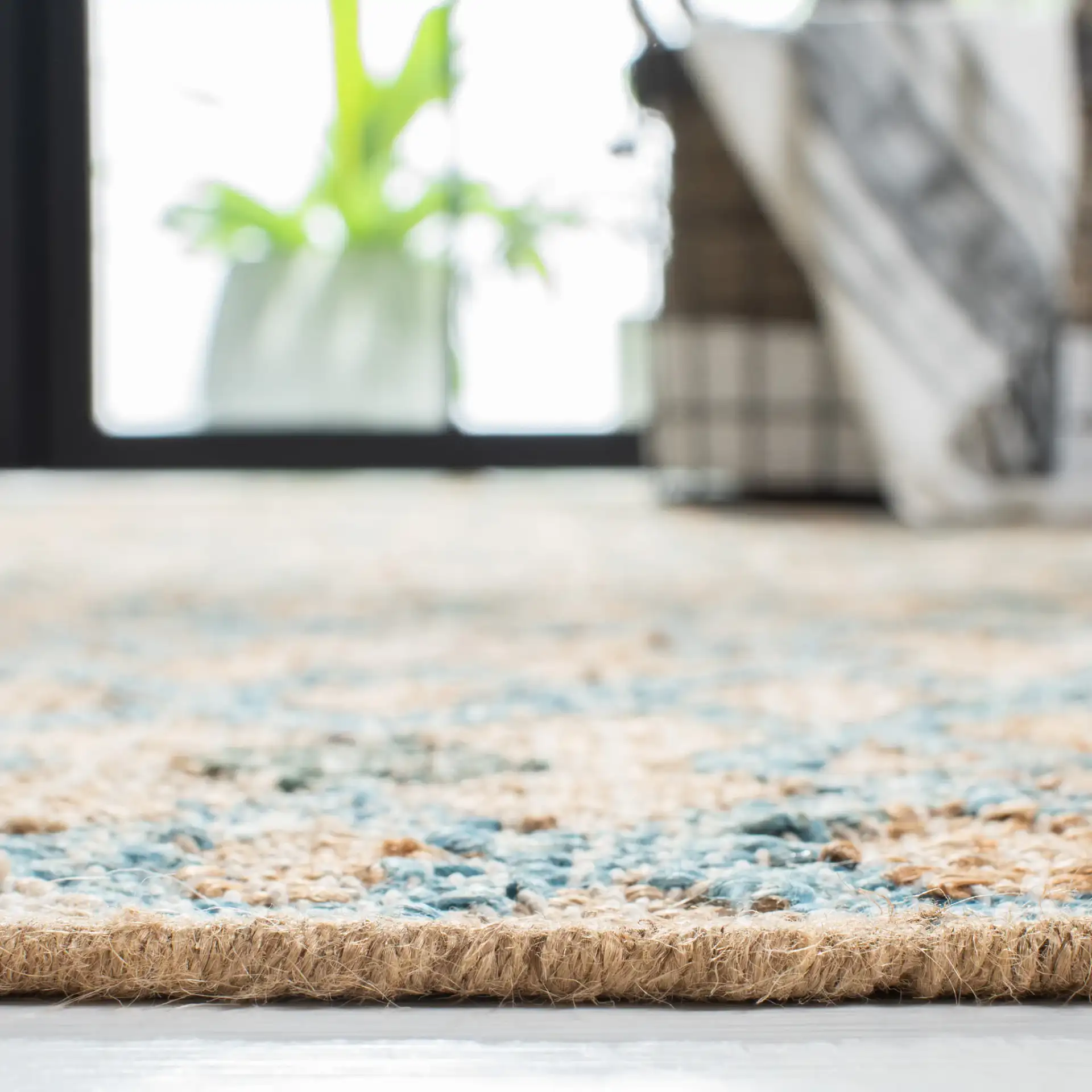 Kilim Diamond Stripe Flatweave Jute Rug in Natural / Blue in a styled room