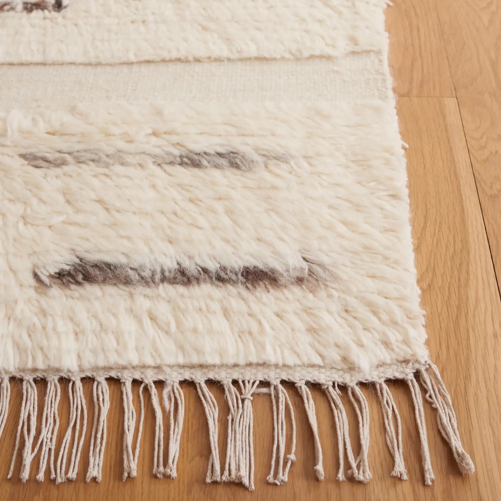 Kenya Broken Stripe Shag Wool Rug in Gray / Ivory in a styled room