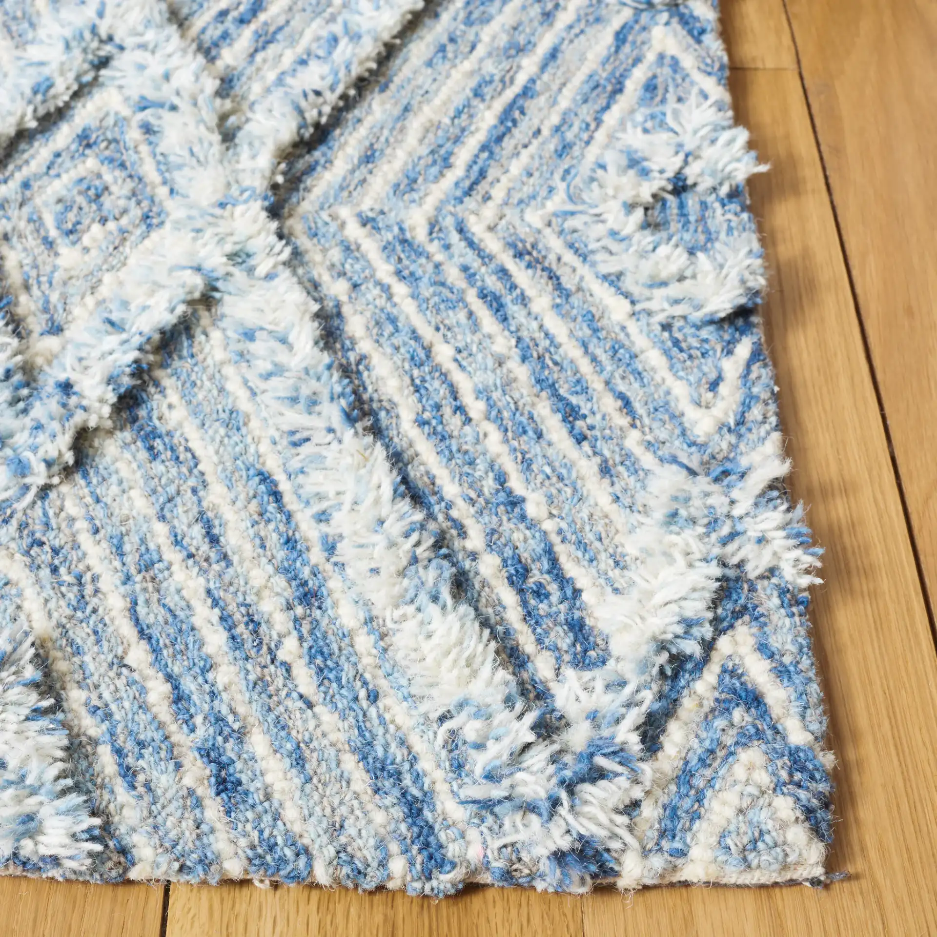 Kenya Nested Diamond Trellis Hand-Tufted Wool Rug in Blue / Ivory in a styled room