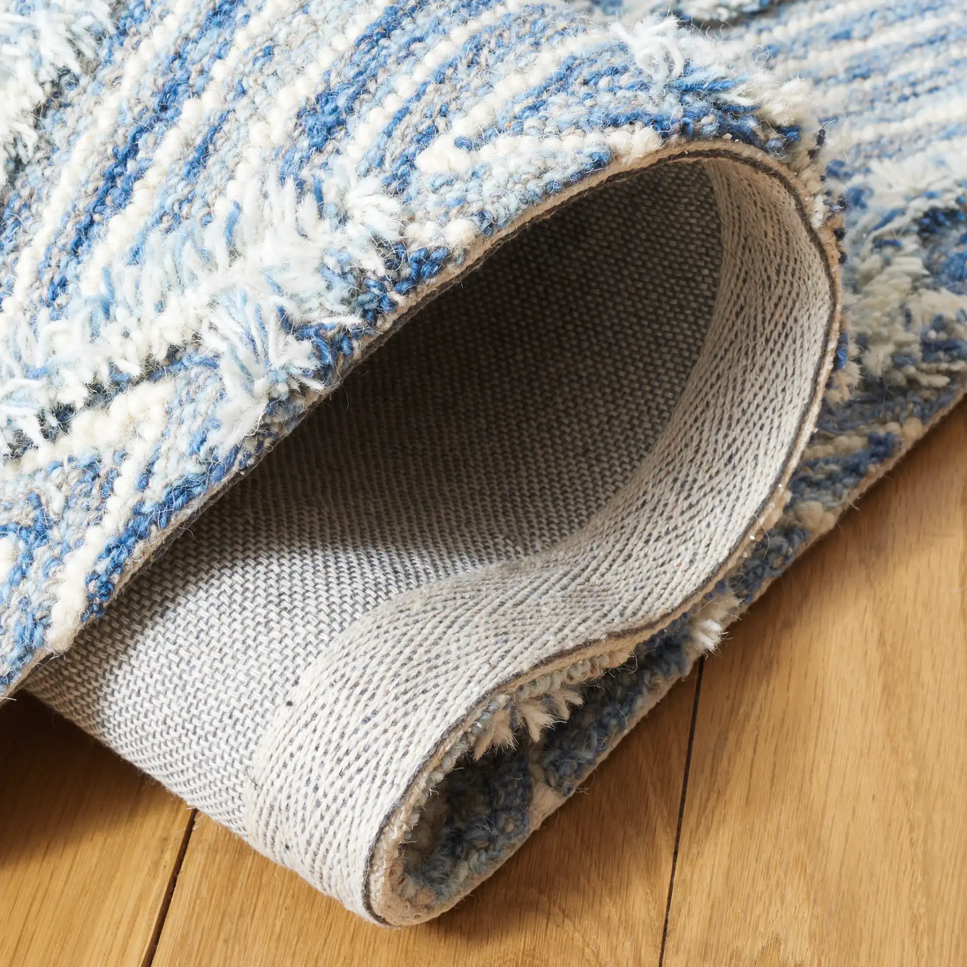 Kenya Nested Diamond Trellis Hand-Tufted Wool Rug in Blue / Ivory in a styled room
