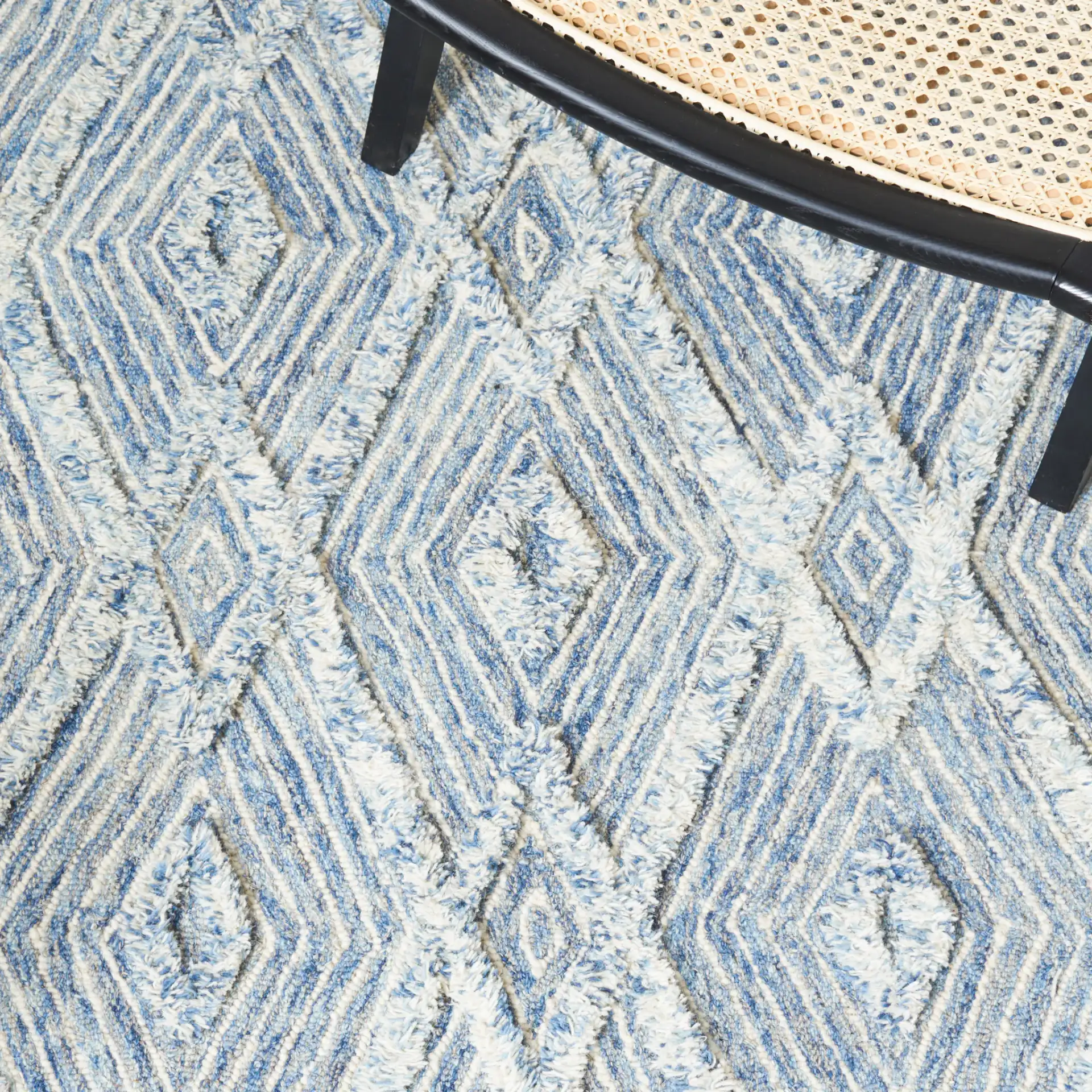 Kenya Nested Diamond Trellis Hand-Tufted Wool Rug in Blue / Ivory in a styled room