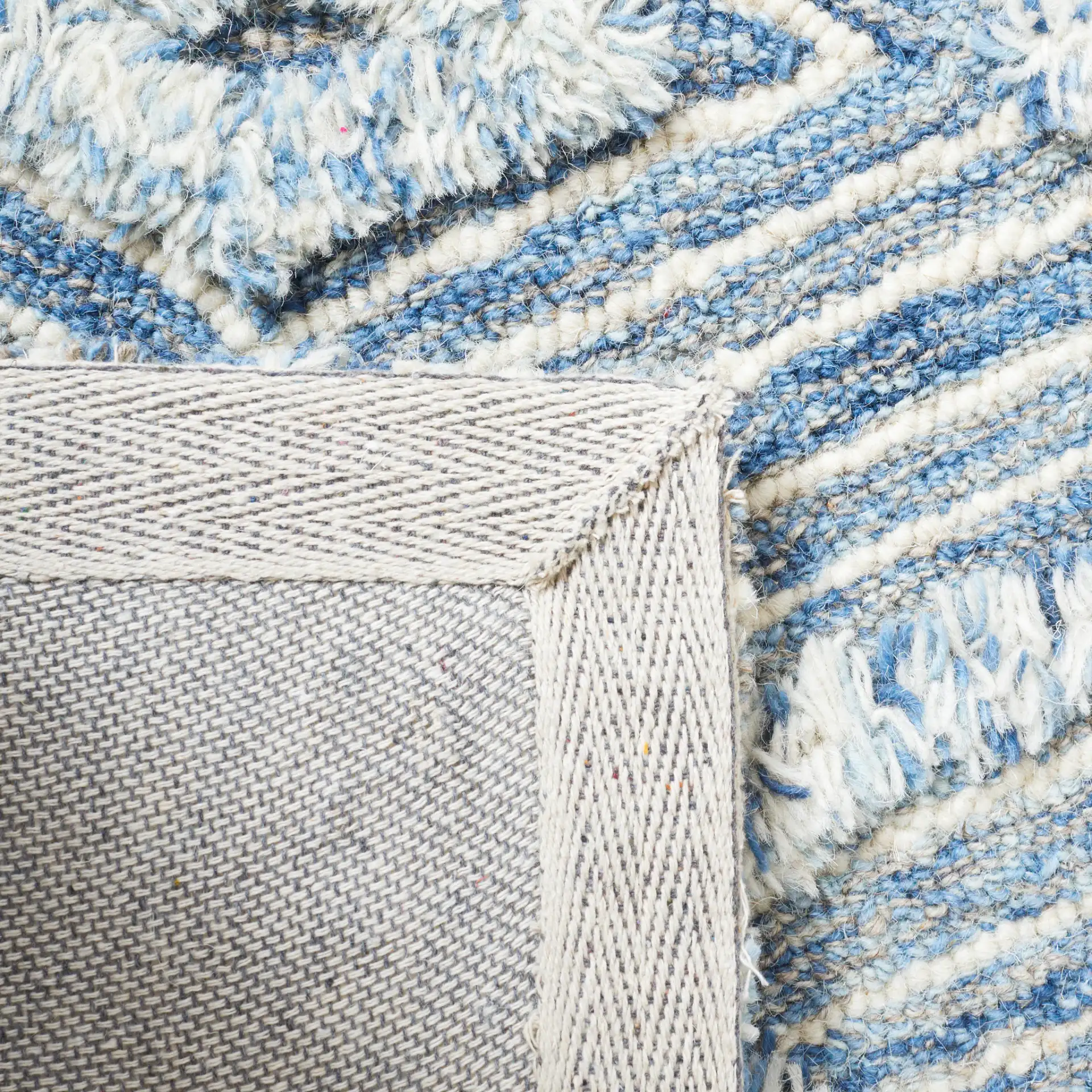 Kenya Nested Diamond Trellis Hand-Tufted Wool Rug in Blue / Ivory in a styled room