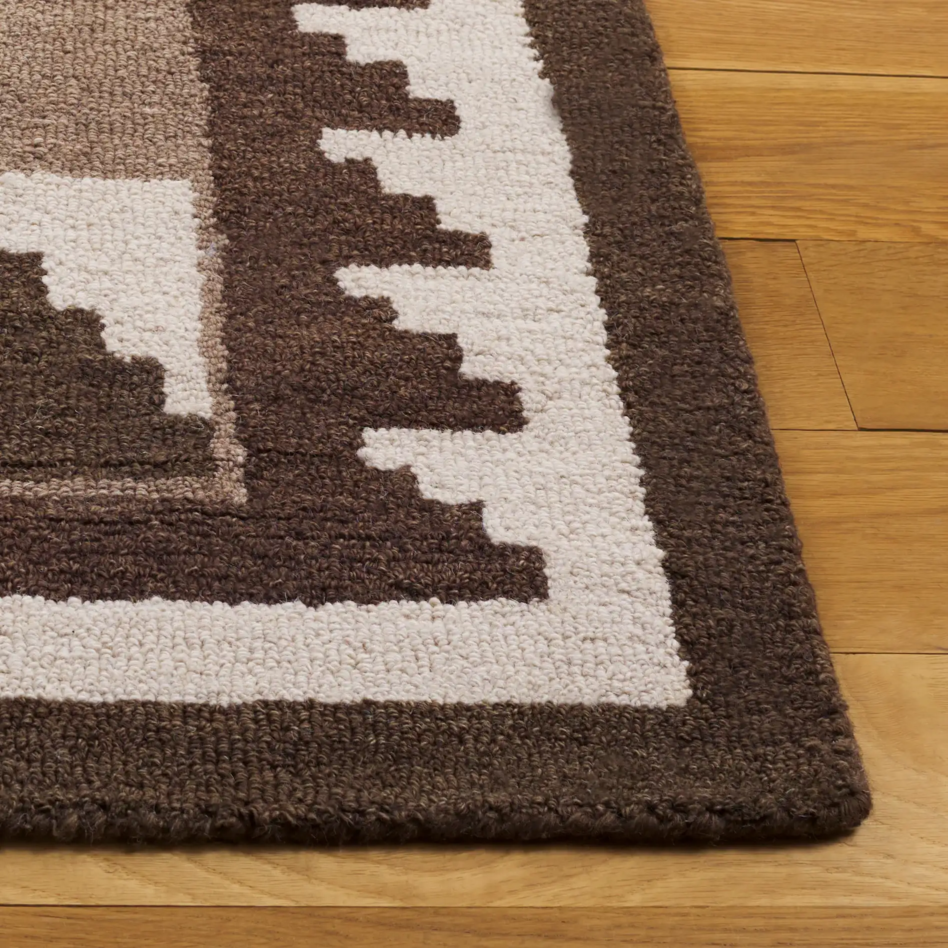 Kenya Stepped Chevron Hand-Tufted Wool Rug in Brown / Ivory in a styled room