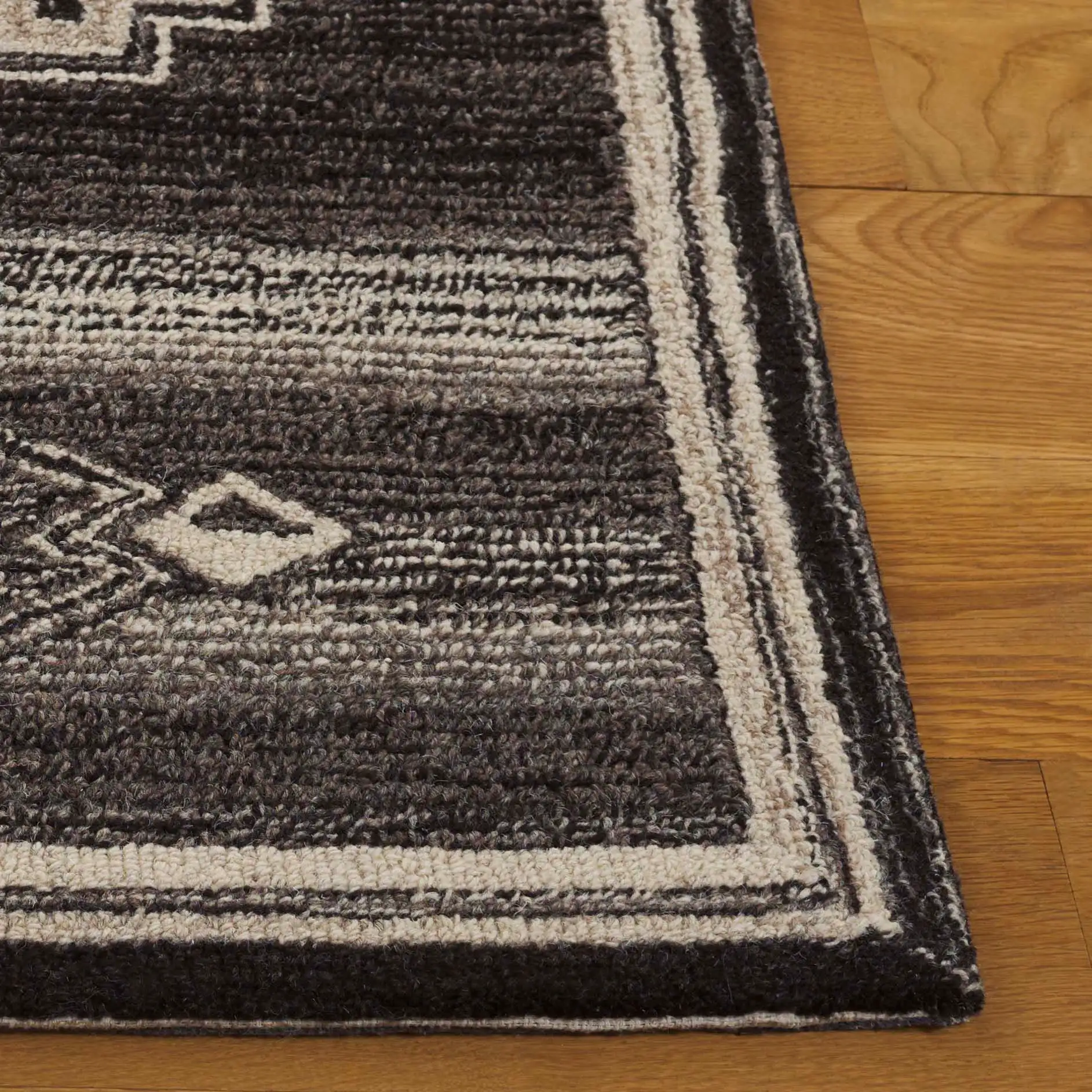 Kenya Stepped Medallion Hand-Tufted Wool Rug in Brown / Ivory in a styled room