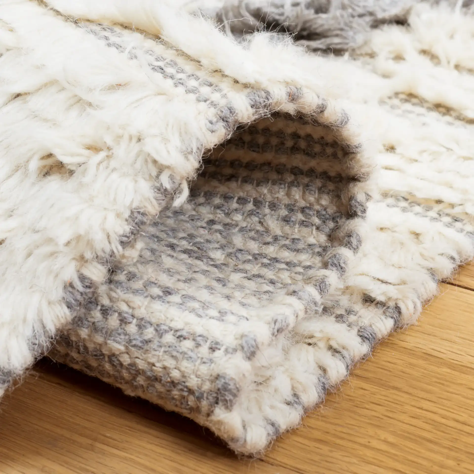 Kenya Textured Diamond Trellis Hand-Woven Shag Wool Rug in Ivory / Gray in a styled room