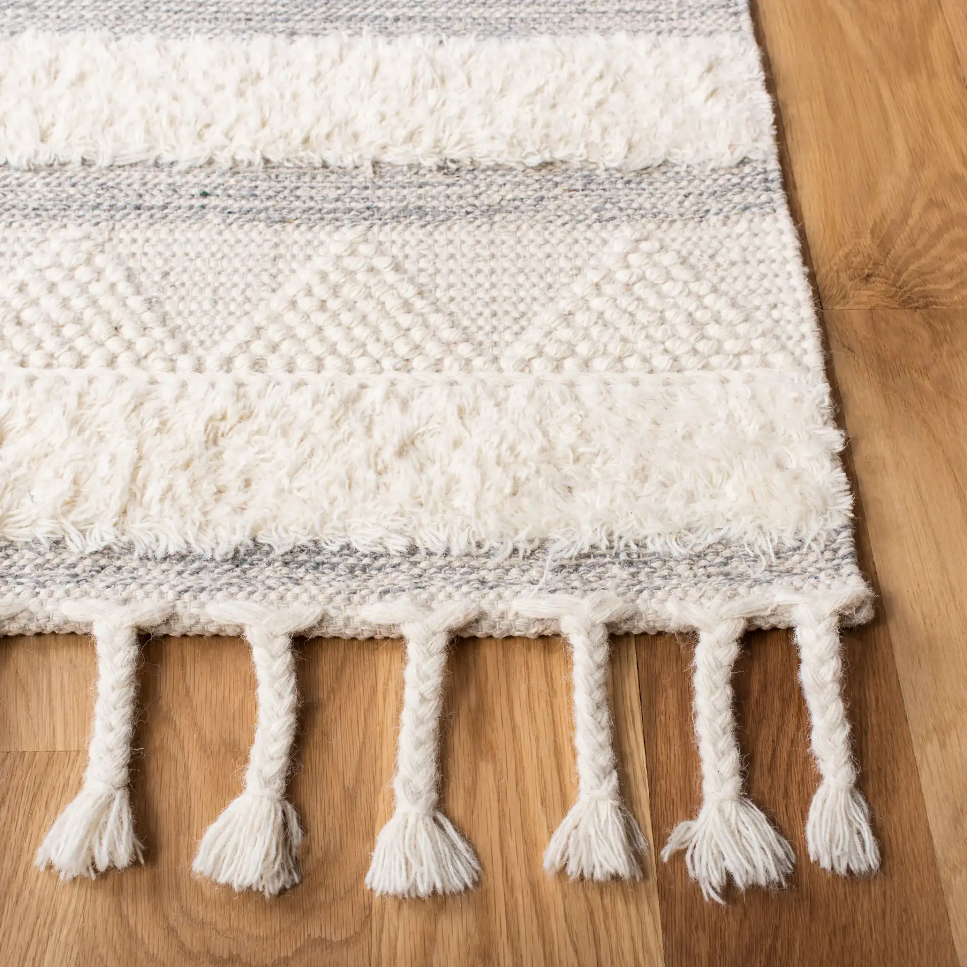 Kenya Striped Triangle Hand-Woven Wool Rug in Ivory / Gray in a styled room