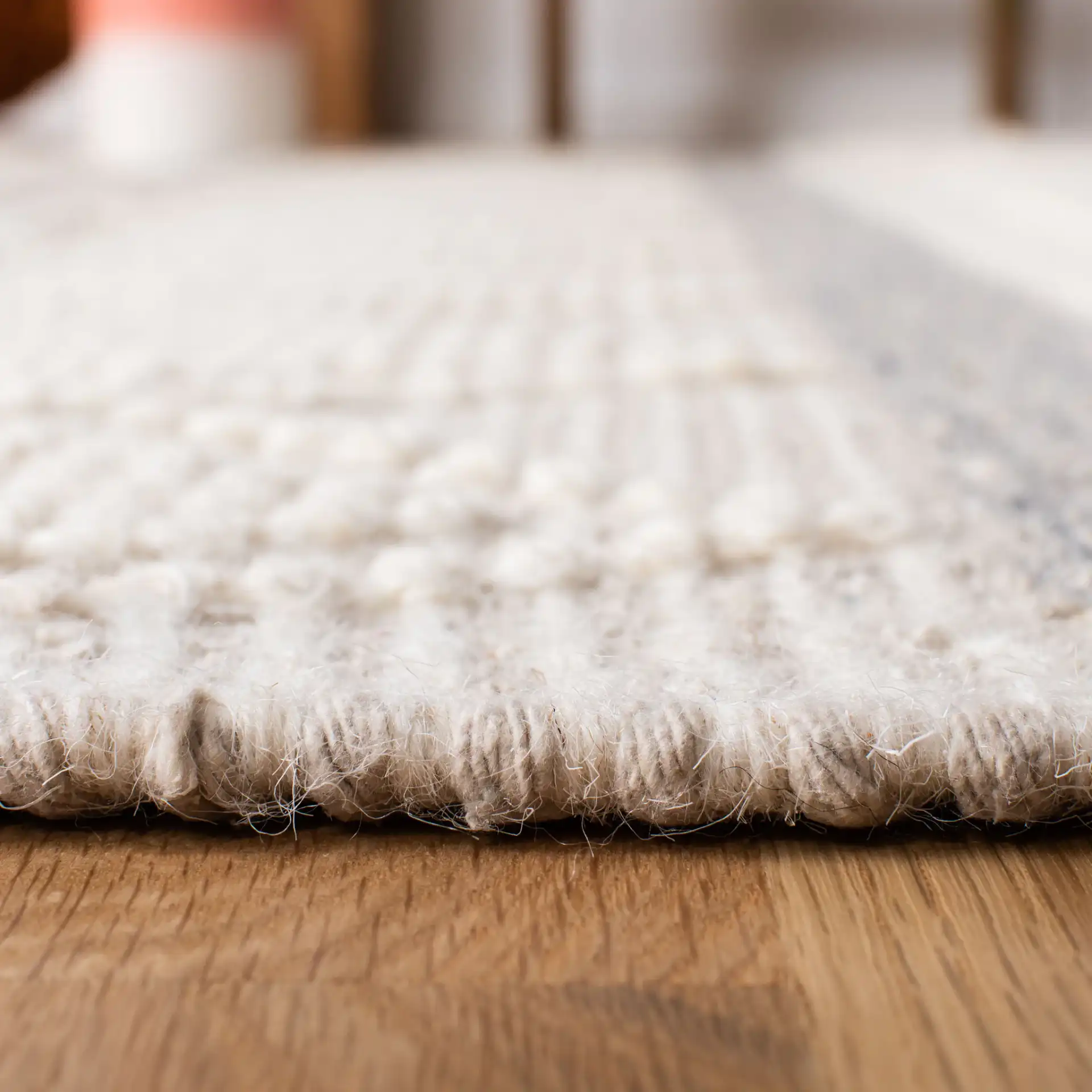 Kenya Striped Triangle Hand-Woven Wool Rug in Ivory / Gray in a styled room