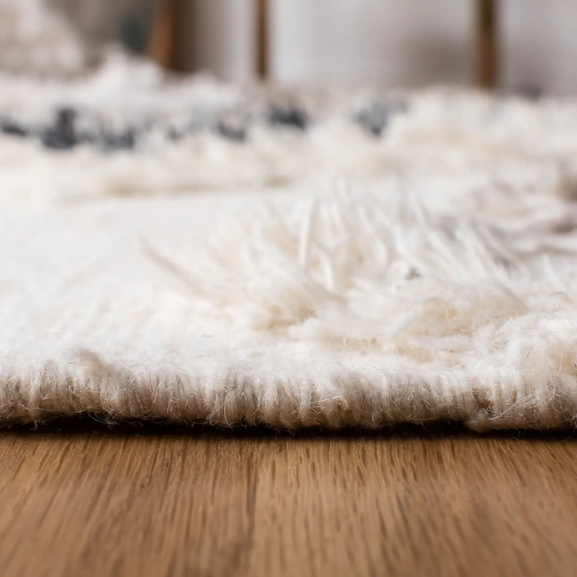 Kenya Diamond Hand-Woven Shag Wool Rug in Gray / Black in a styled room