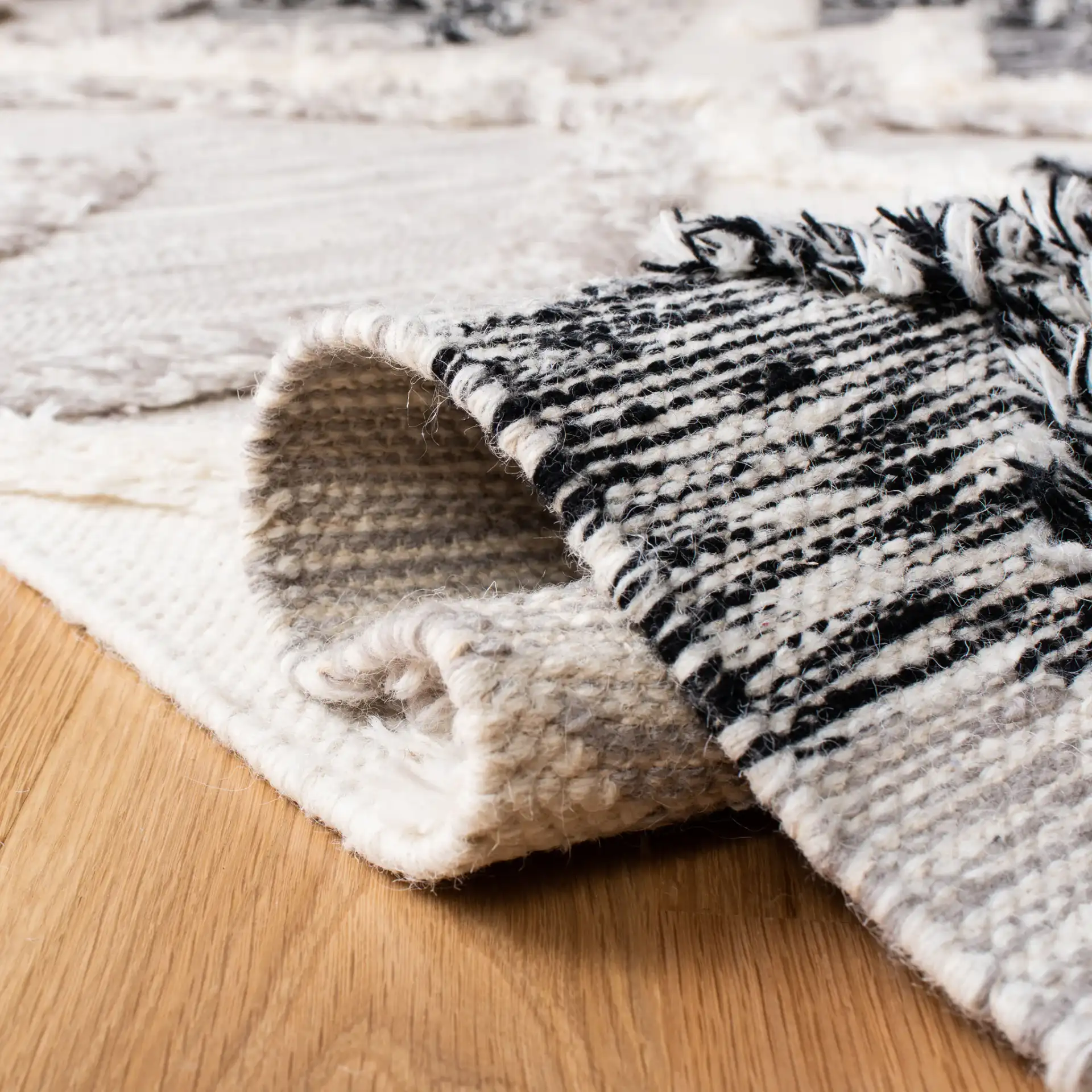 Kenya Diamond Hand-Woven Shag Wool Rug in Gray / Black in a styled room