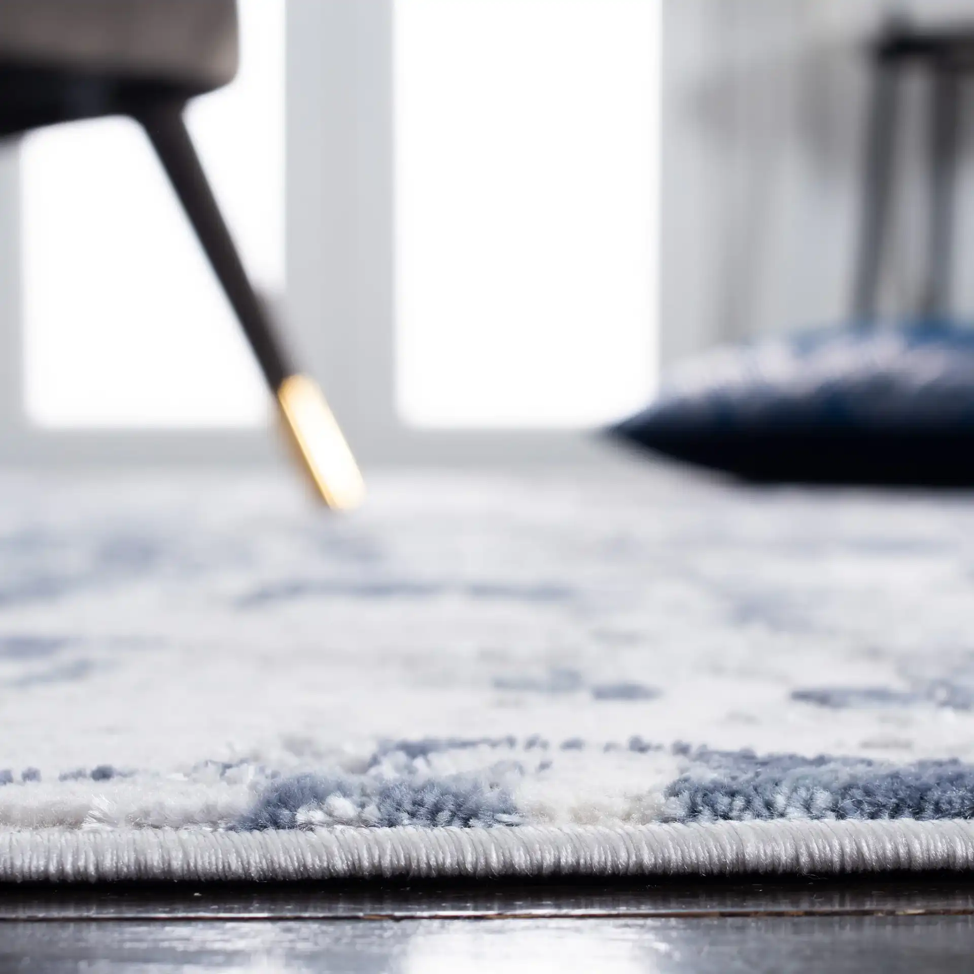 Lagoon Abstract Drip Rug in Gray / Blue in a styled room