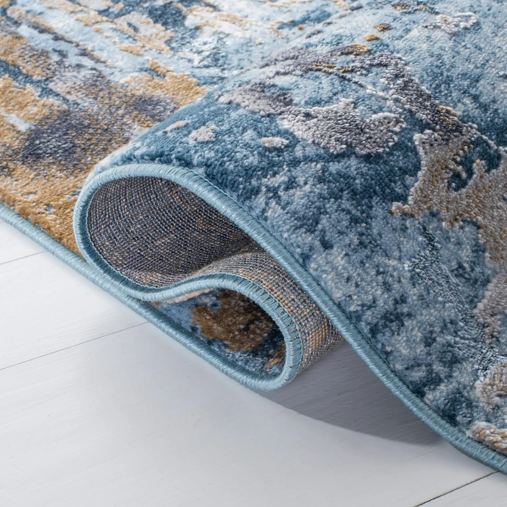 Lagoon Abstract Drip Rug in Gray / Blue in a styled room