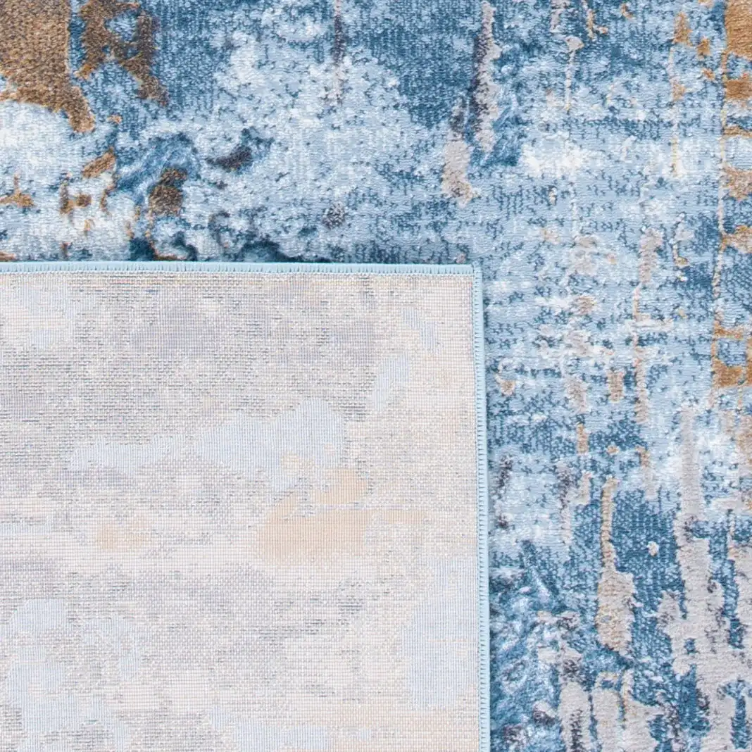 Lagoon Abstract Drip Rug in Gray / Blue in a styled room