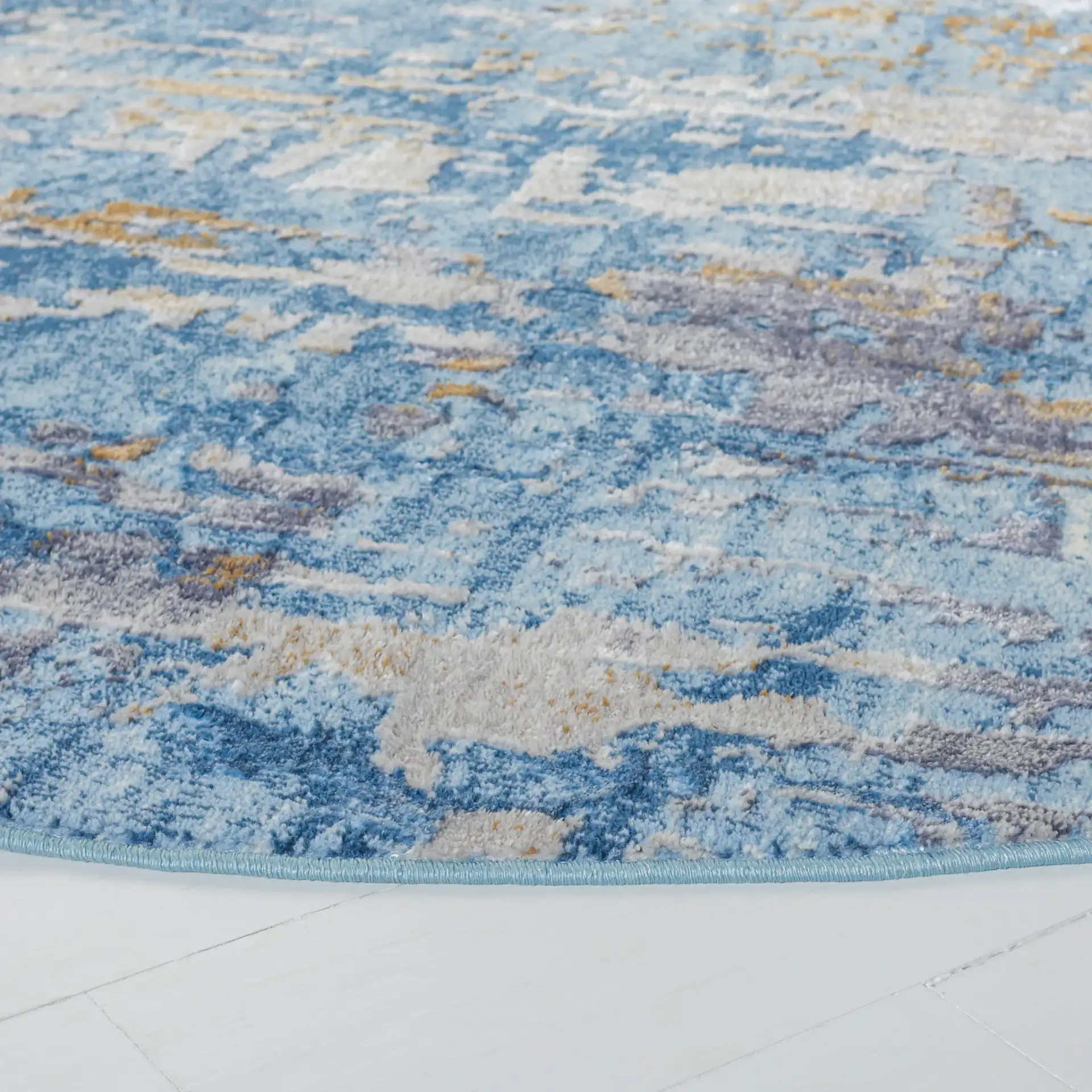 Lagoon Abstract Drip Rug in Gray / Blue in a styled room