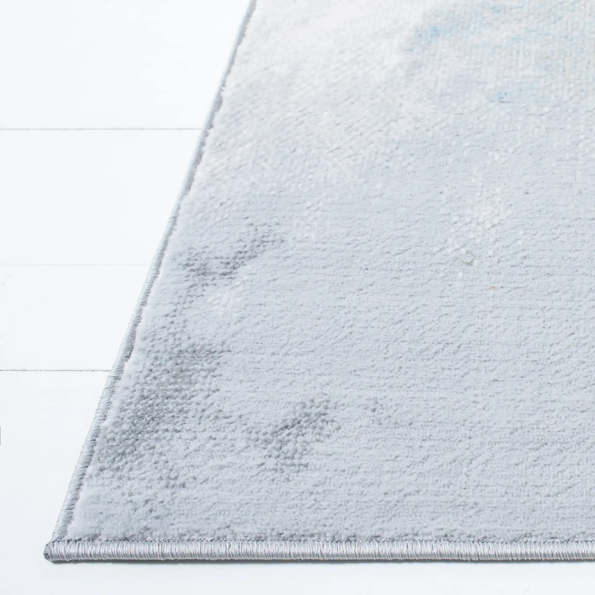 Lagoon Abstract Cloud Rug in Blue / Beige in a styled room