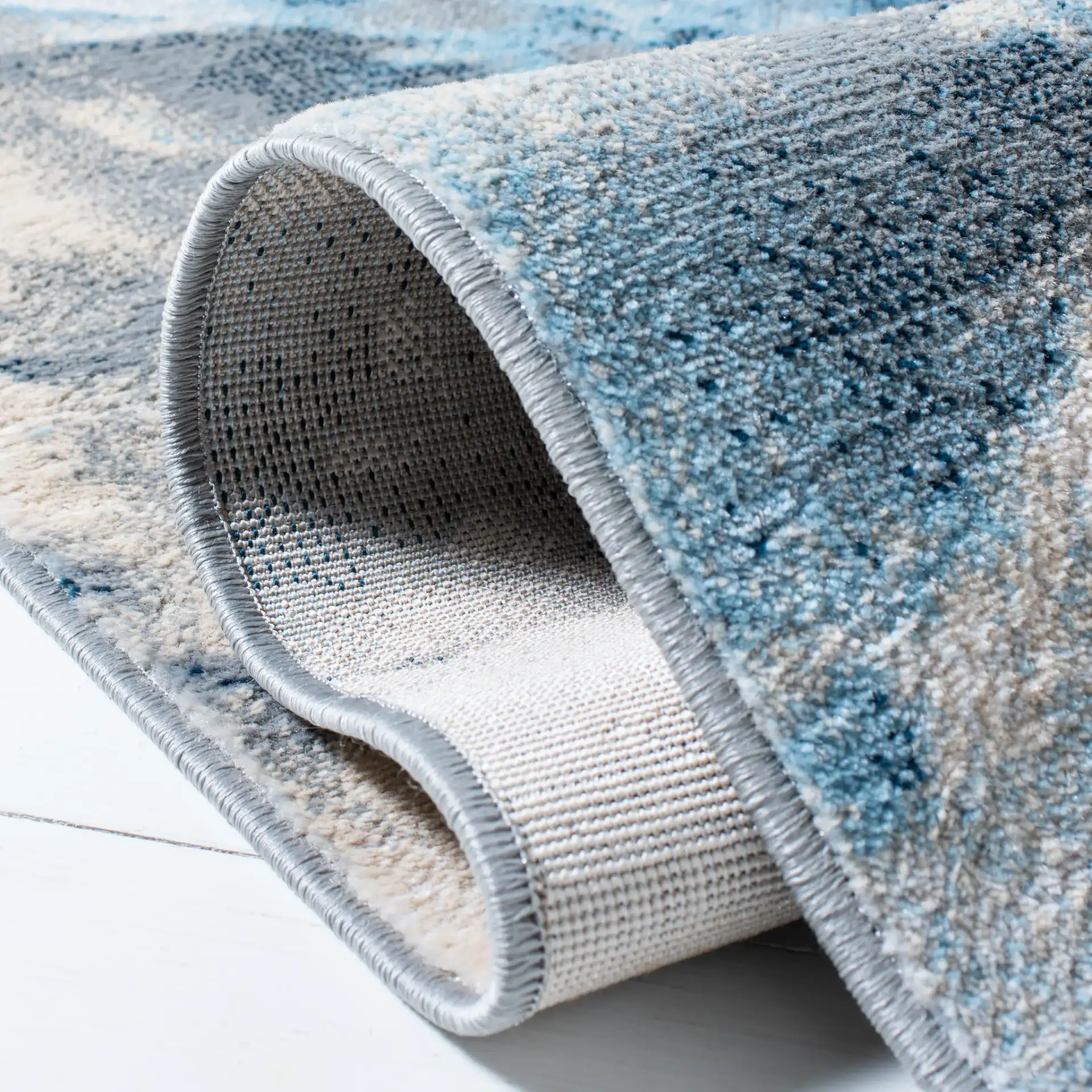 Lagoon Abstract Cloud Rug in Blue / Beige in a styled room